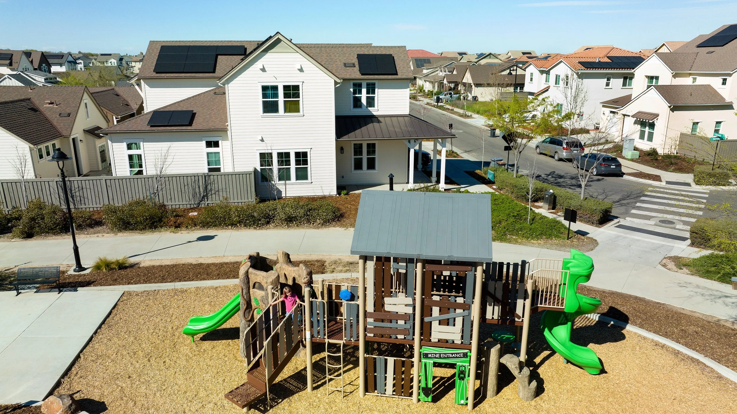 Child playing on a play structure in a residential community.