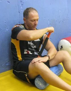 Using the Tiger Tail to roll the biceps, upper arm and forearms