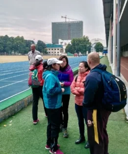 The lovely Naomi Li in the orange puffy jacket translating the conversation between a Womens T & F Coach and myself