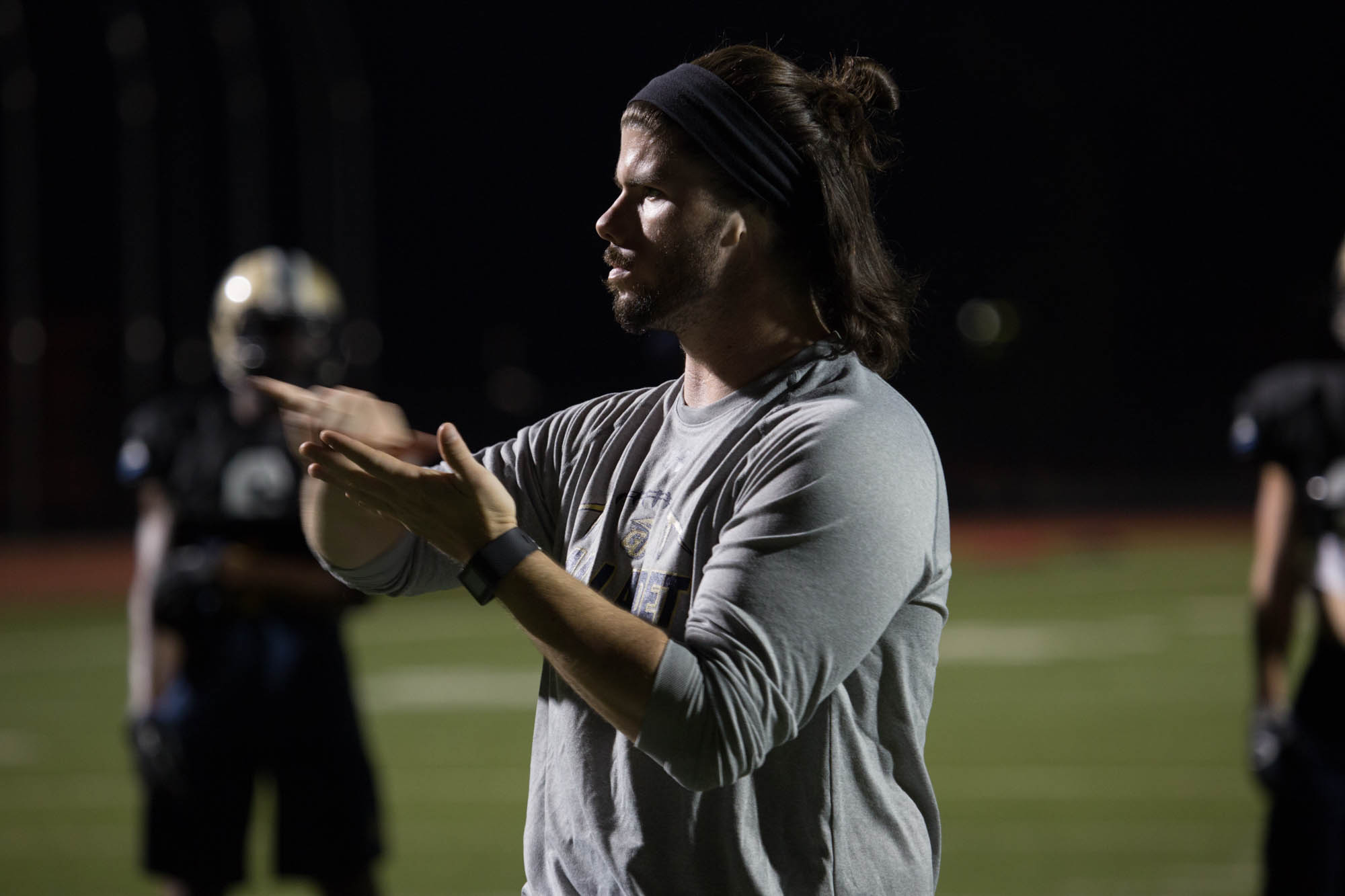 Shelby Bean, 25, signs a play to his linebackers during practice September 14, 2016 at Gallaudet University.