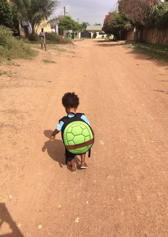 Talib on his way to school. Just like a turtle, we carry home wherever we are. 