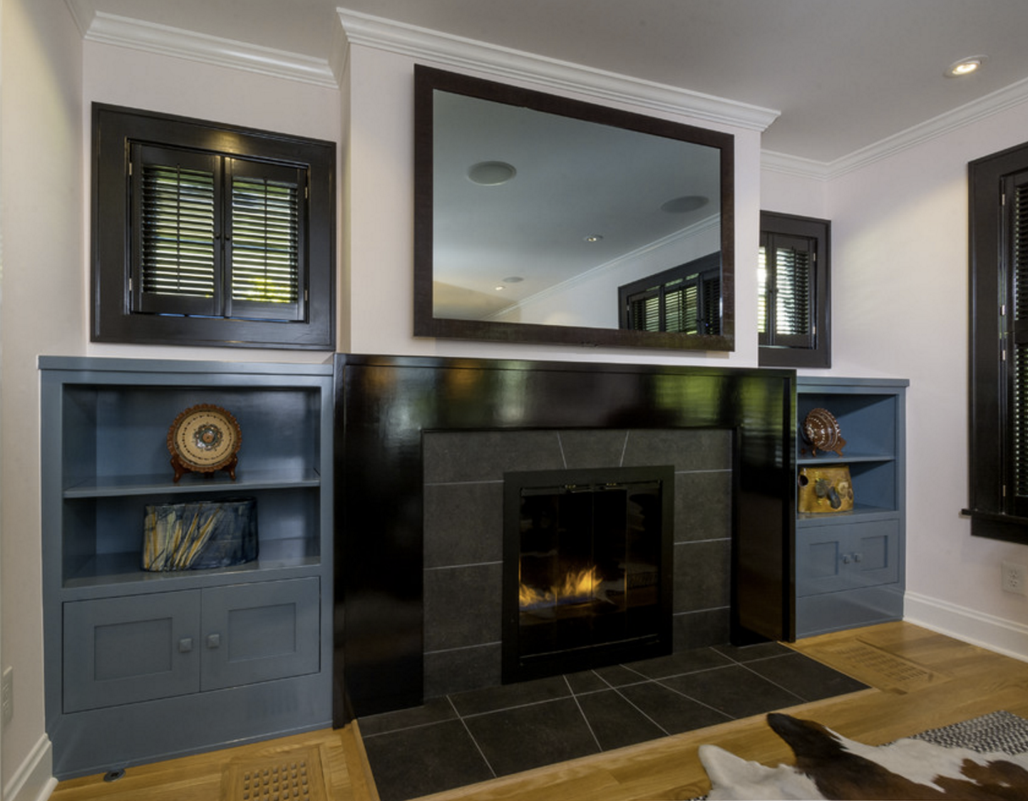 We did a modern take on craftsman style for the built in bookcases and mantle, using color and gloss finishes to keep it fresh. 