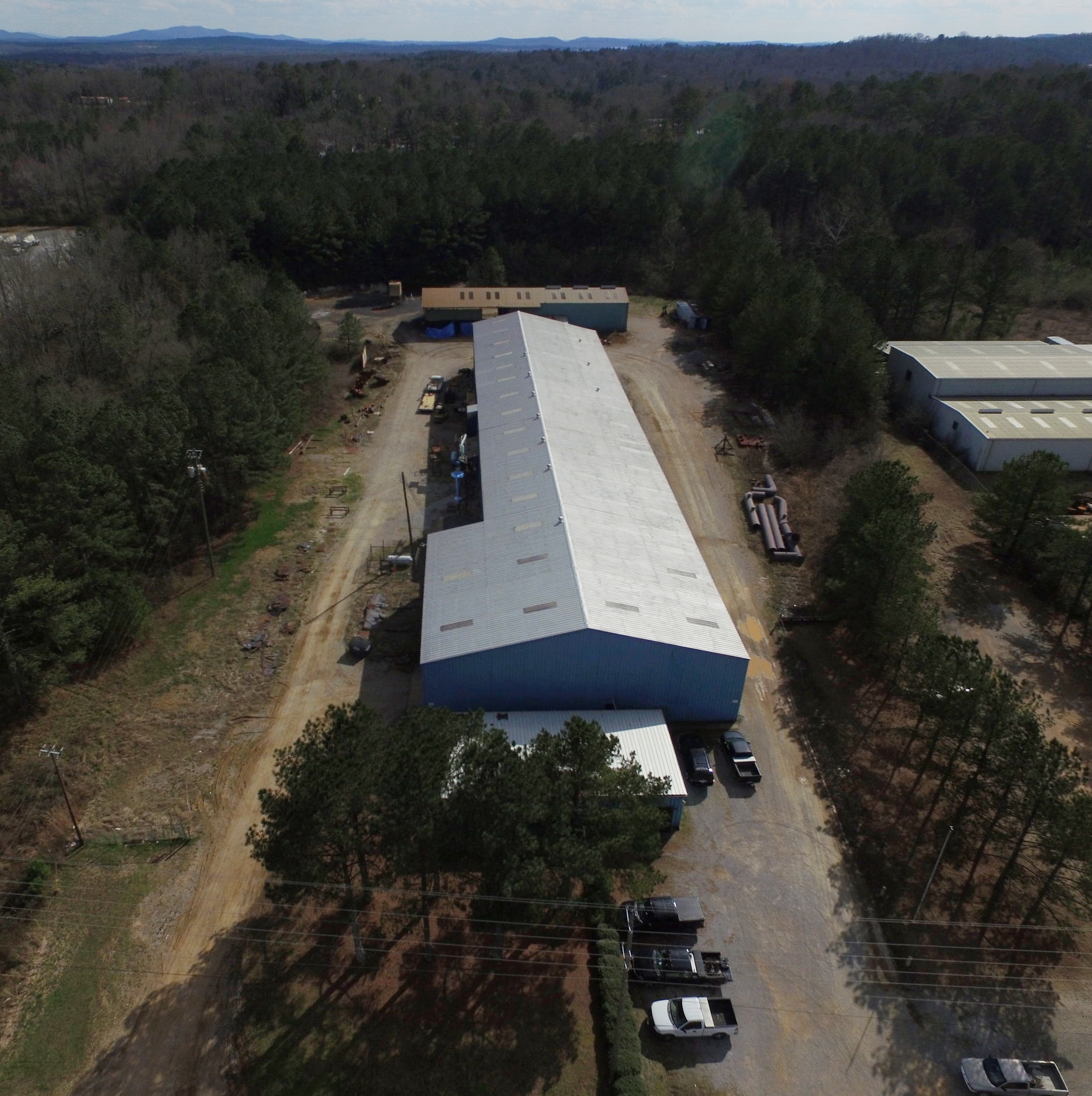 Aerial view of the fabrication shop with blasting and paint booth at the rear.