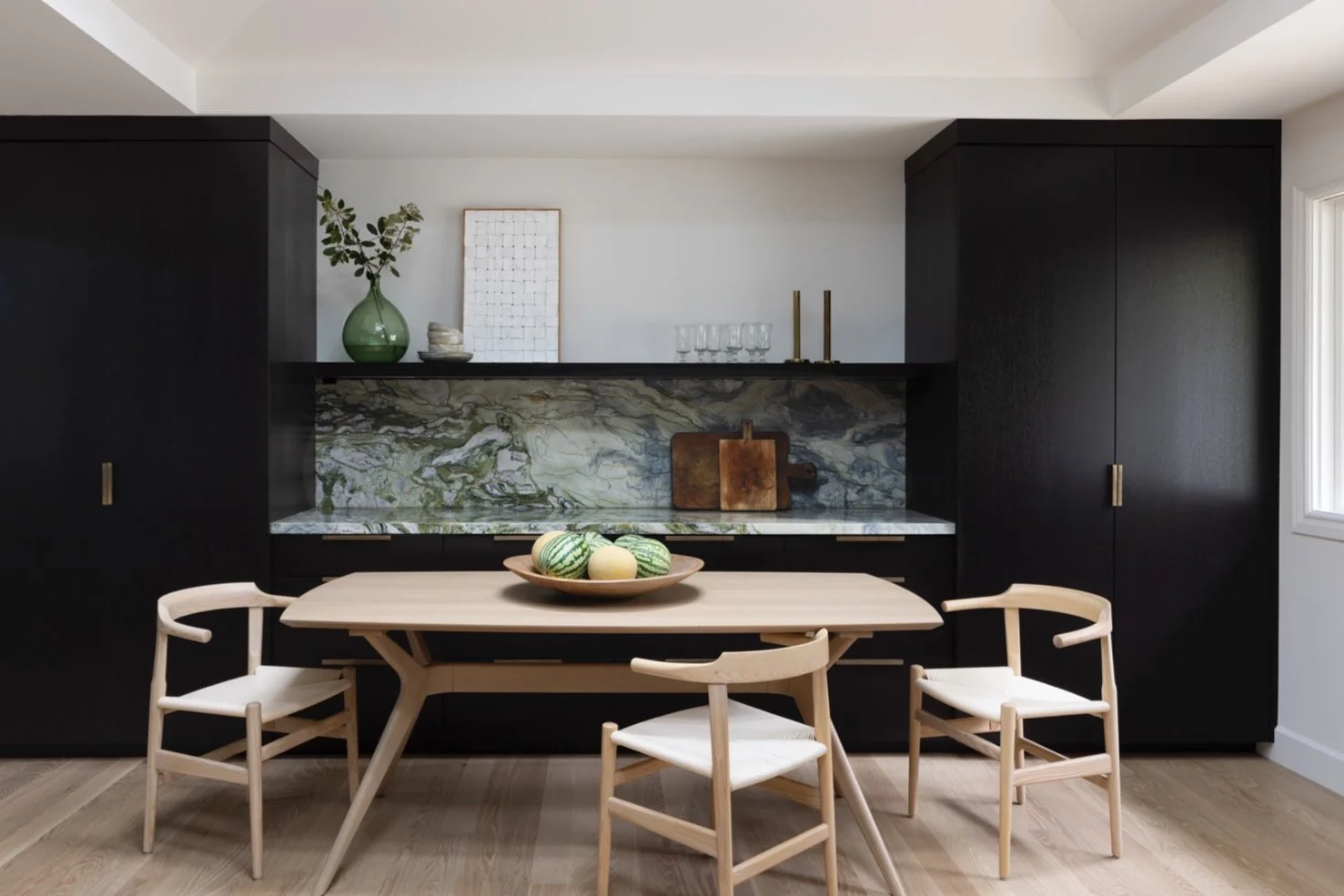 Dark stained oak cabinets and quarzite counters are part of this kitchen remodel designed by Melinda Mandell and built by Guild.