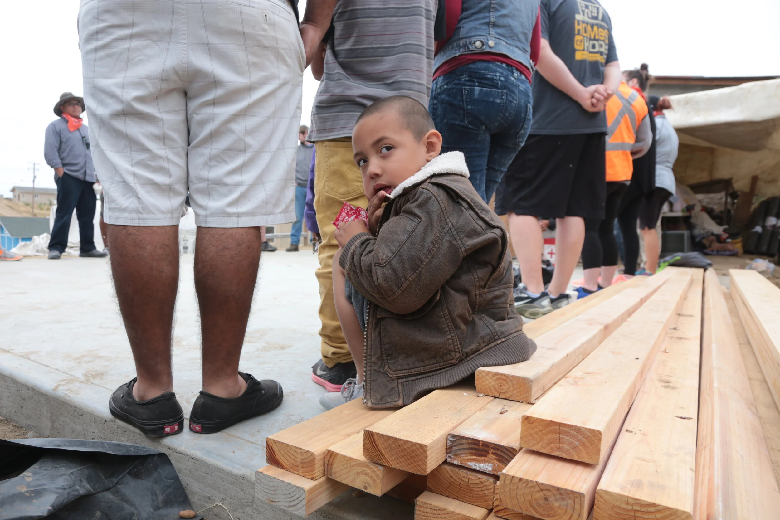 Leonel watching as the team gathers to say a prayer before Day 1 of the build. Prayers go up for safety, speed and a fun team build for a deserving family. 