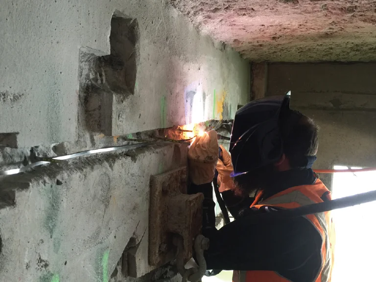 Discrete anodes installed into the beams with the anode titanium ‘tails’ finally welded to the titanium conductor to form the CP zone.