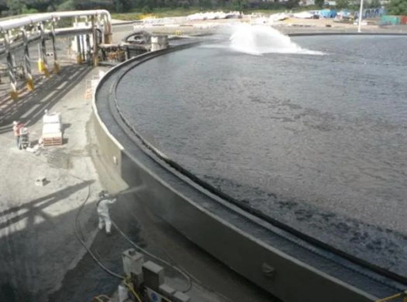 Application of final layer of dry-process gunite over Hybrid anodes and cables wiith tank back in service.