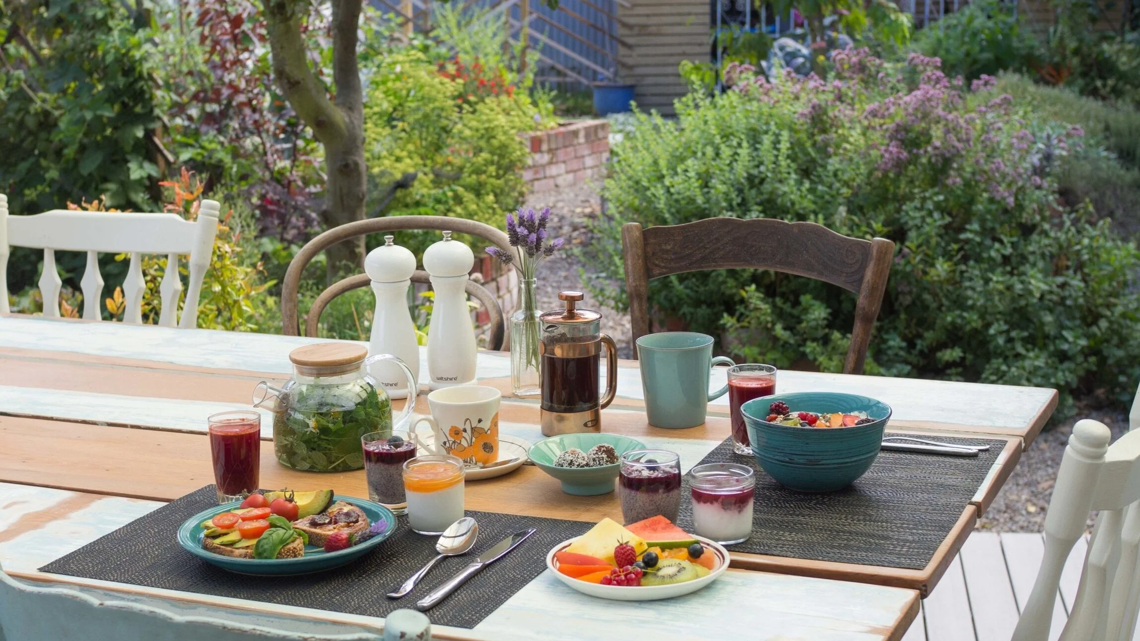 Eco Villa’s zero waste breakfast served on the deck with our edible garden pictured in the background
