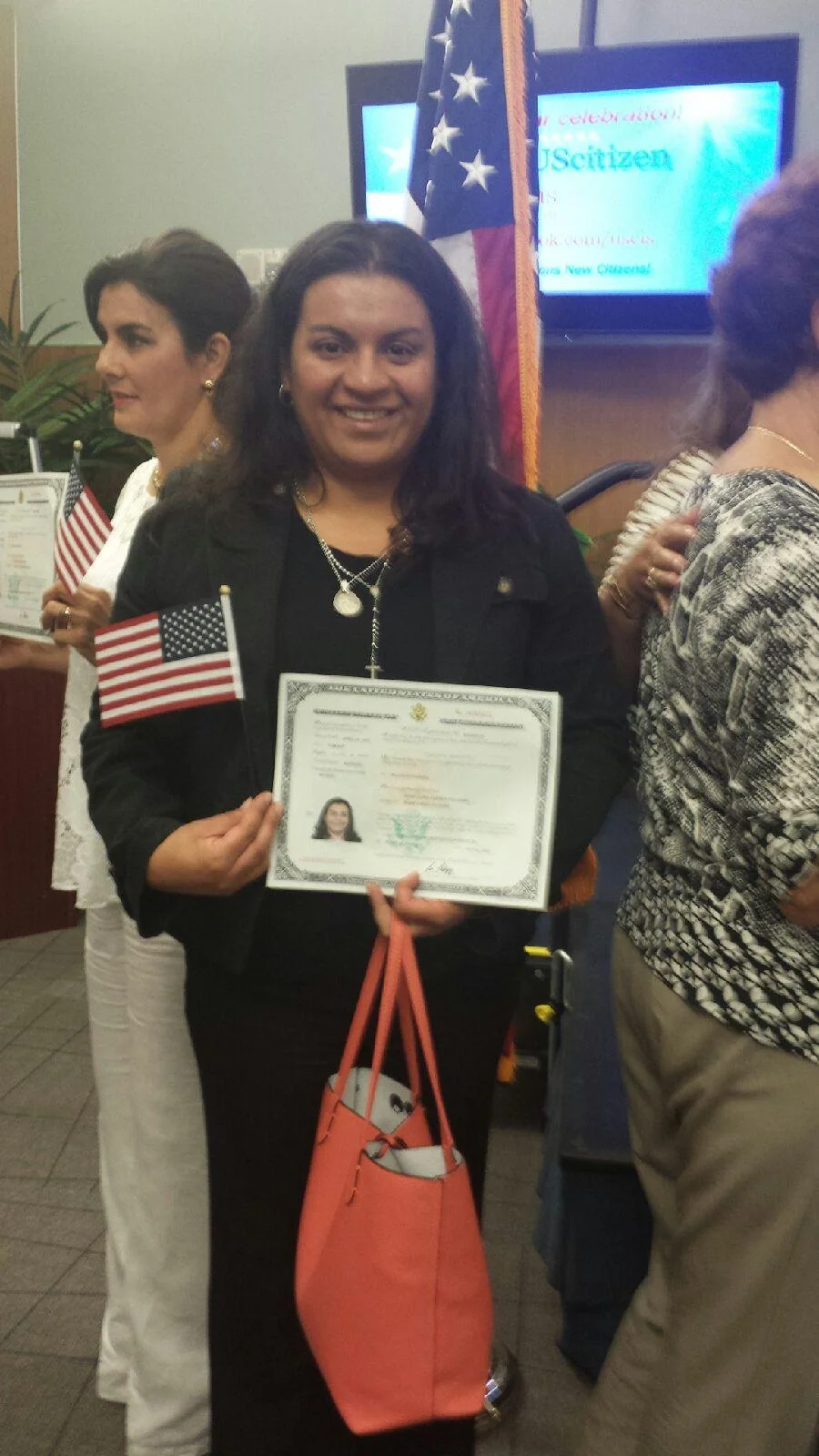 Monica proudly displays her newly received Citizenship Certificate