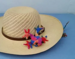Lizzie is under the hat and Frederick is on the hat.