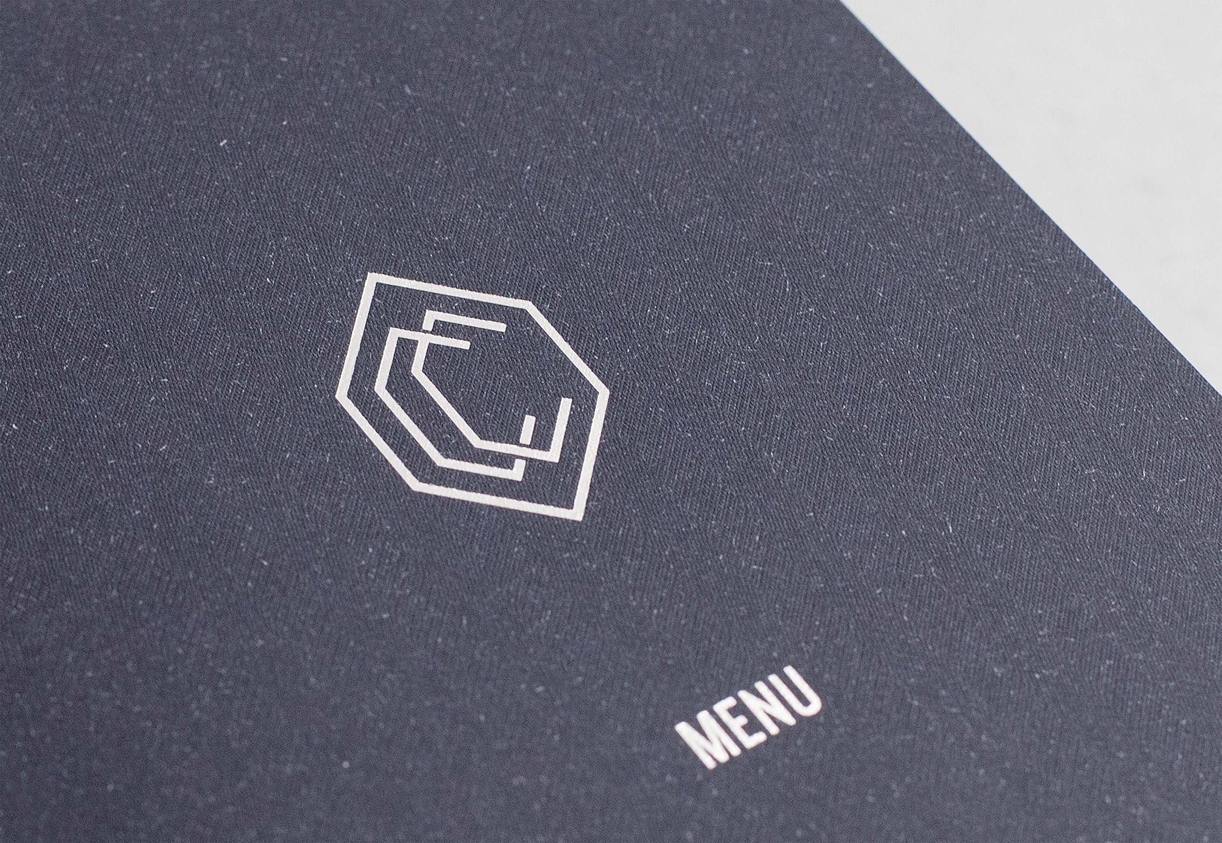 A monogram logo and midnight blue colour palette create a luxurious and old-world aesthetic, working alongside a contemporary internal space and furnishings.