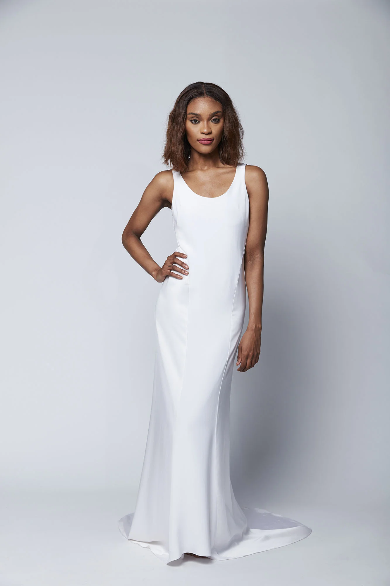 This slinky tank dress with satin side paneling and a low V back is the perfect look for the no frills bride who is seeking effortless chic.