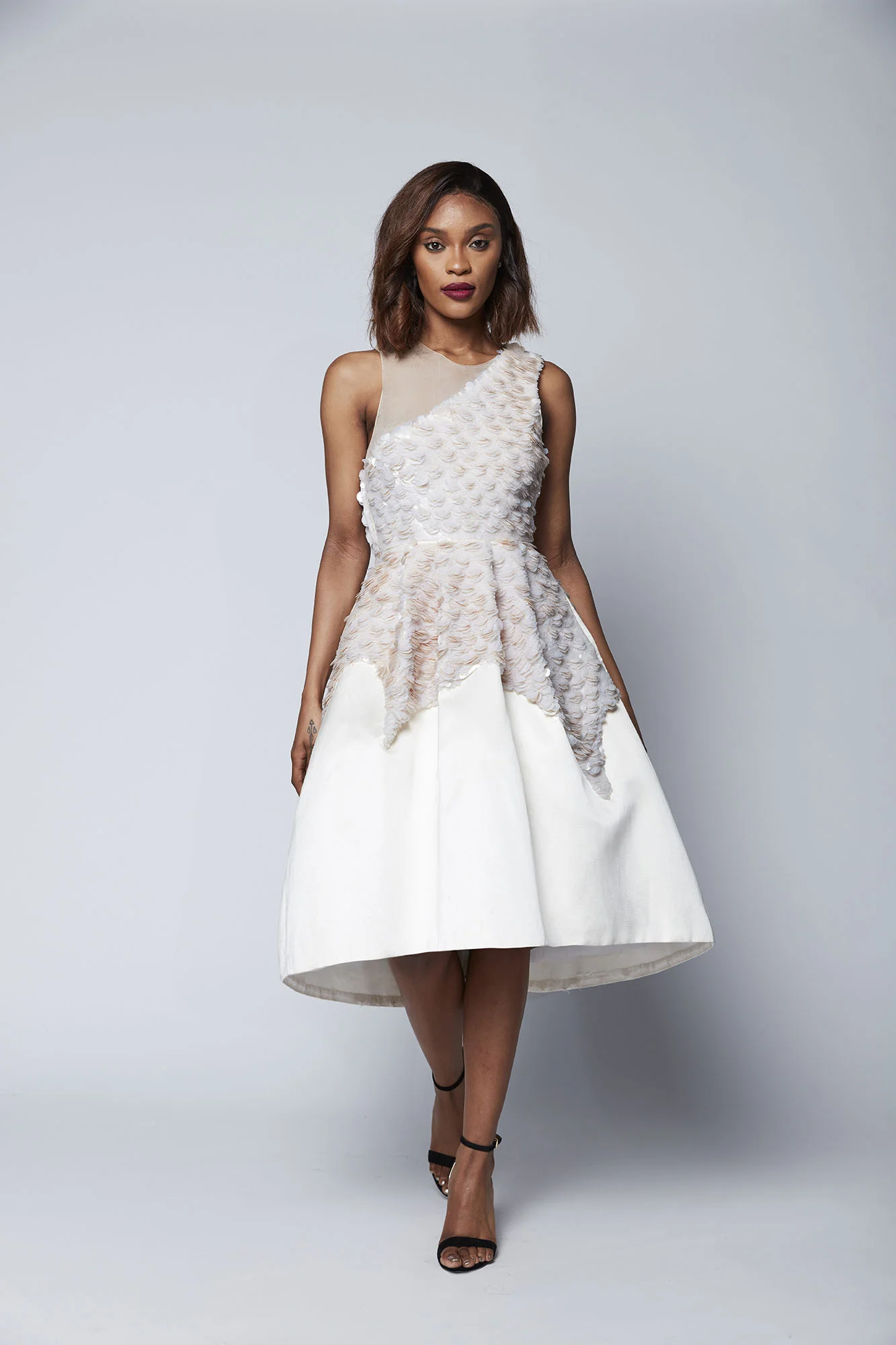 This dramatic tea length dress of layered opaline sequins creates a show stopping look that is perfect for the most glamorous of occasions and ideal for the bride who wants to dance the night away.
