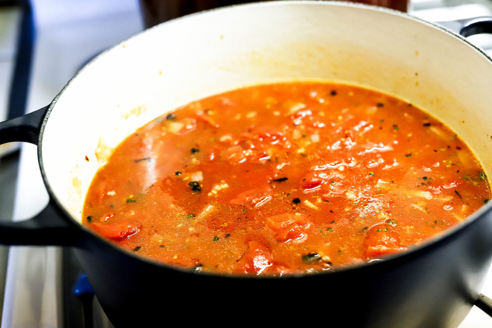 Easy homemade gluten-free and vegan tomato soup cooking in a pot