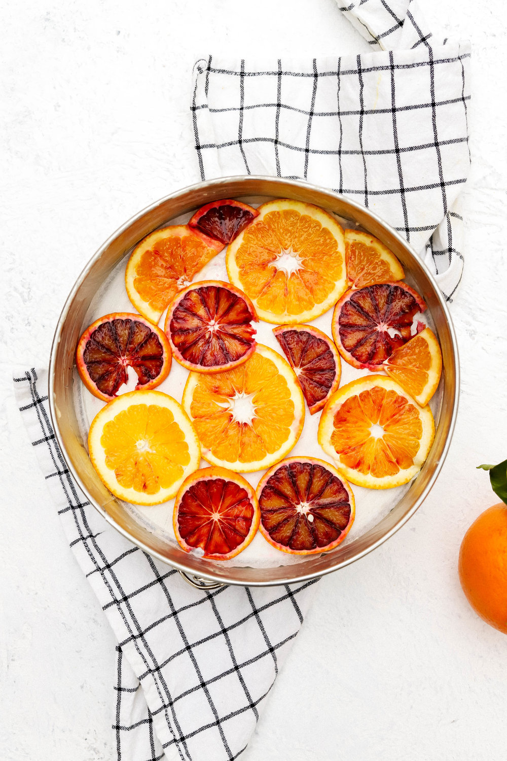 sliced oranges at the bottom of a spring form pan