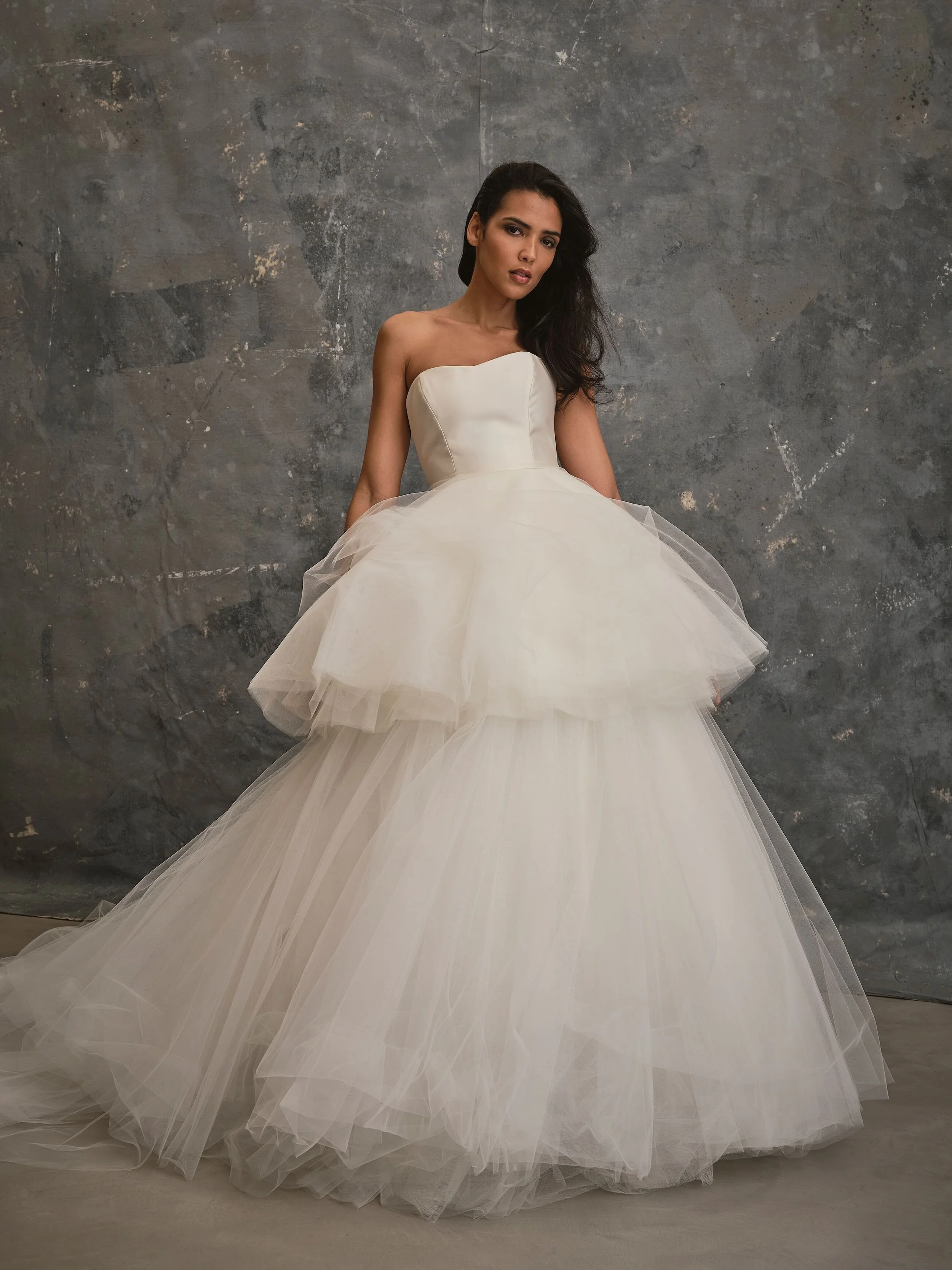 Strapless wedding gown with voluminous layered tulle skirt and contemporary bridal silhouette