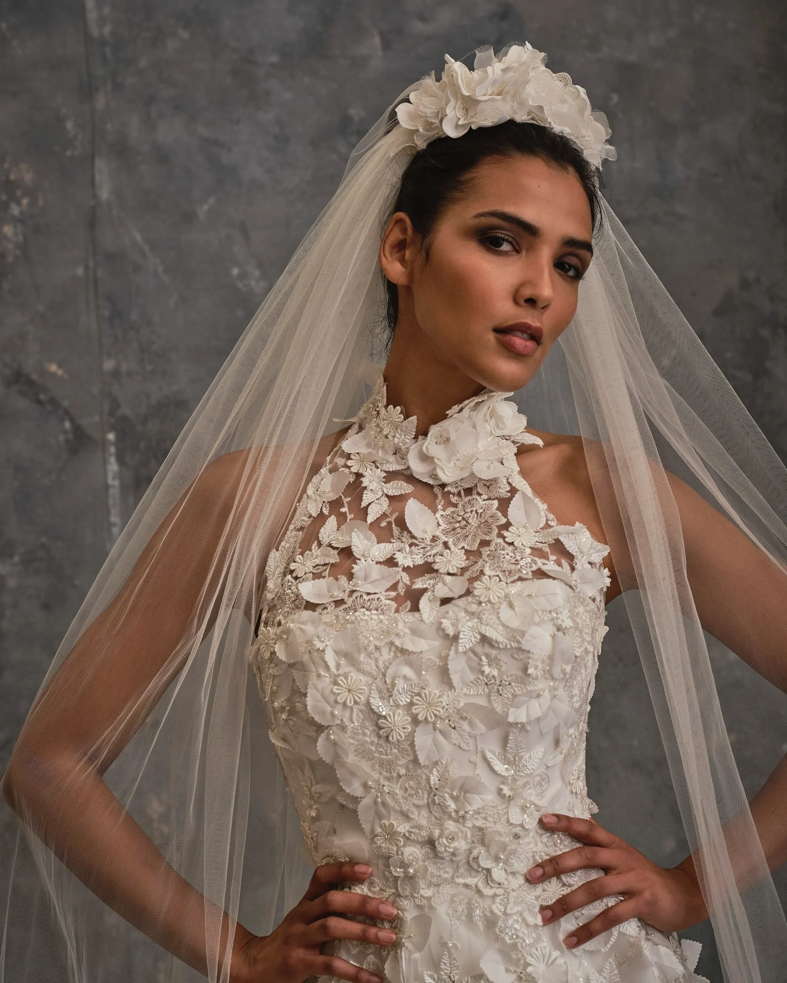 Detailed close-up of 3D floral appliqué bodice with illusion neckline and couture embroidery and matching handmade silk flower crown tulle veil