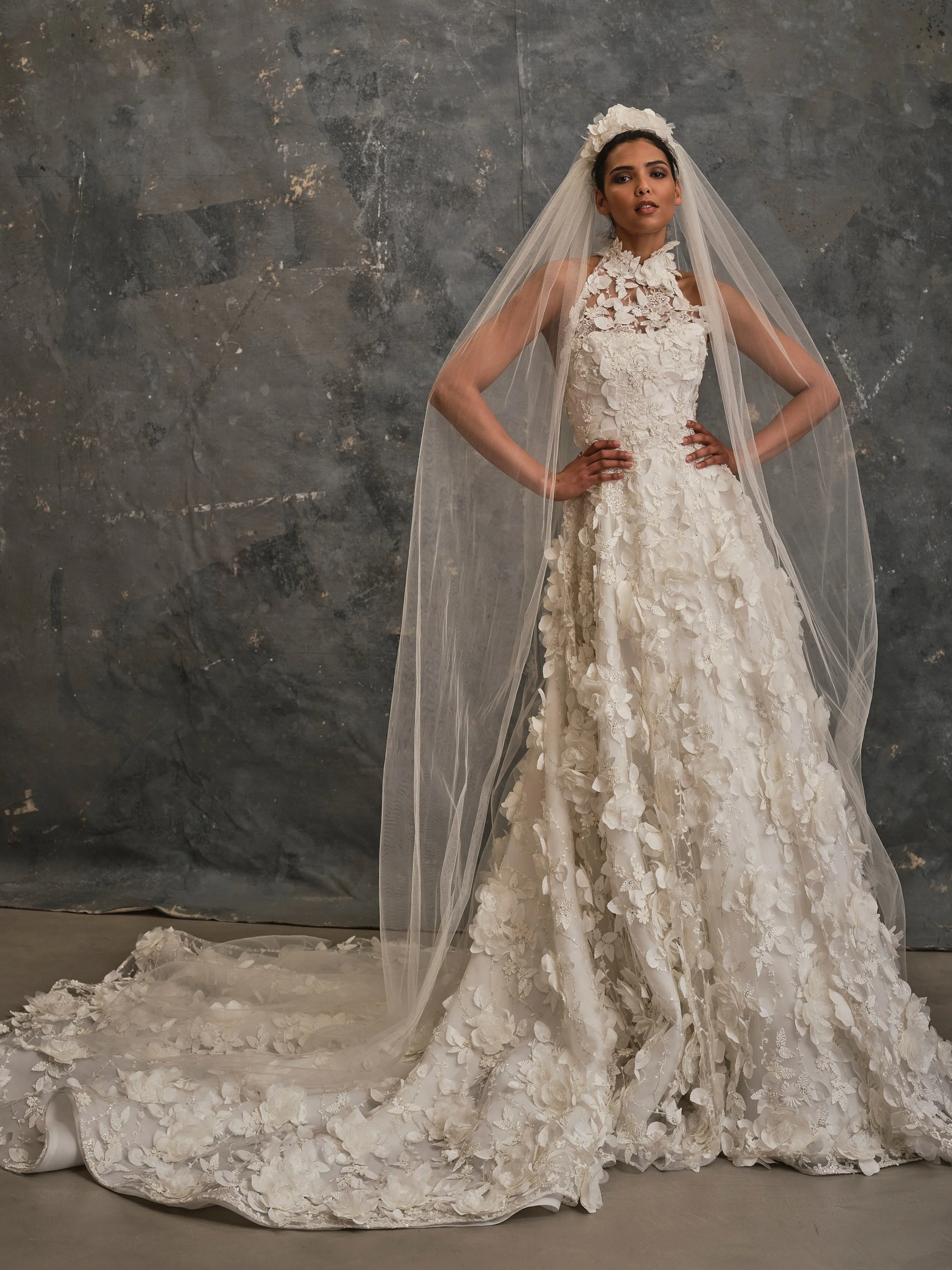 Couture A-line wedding dress with hand-applied 3D floral appliqués, dramatic cathedral train and flower crown veil.