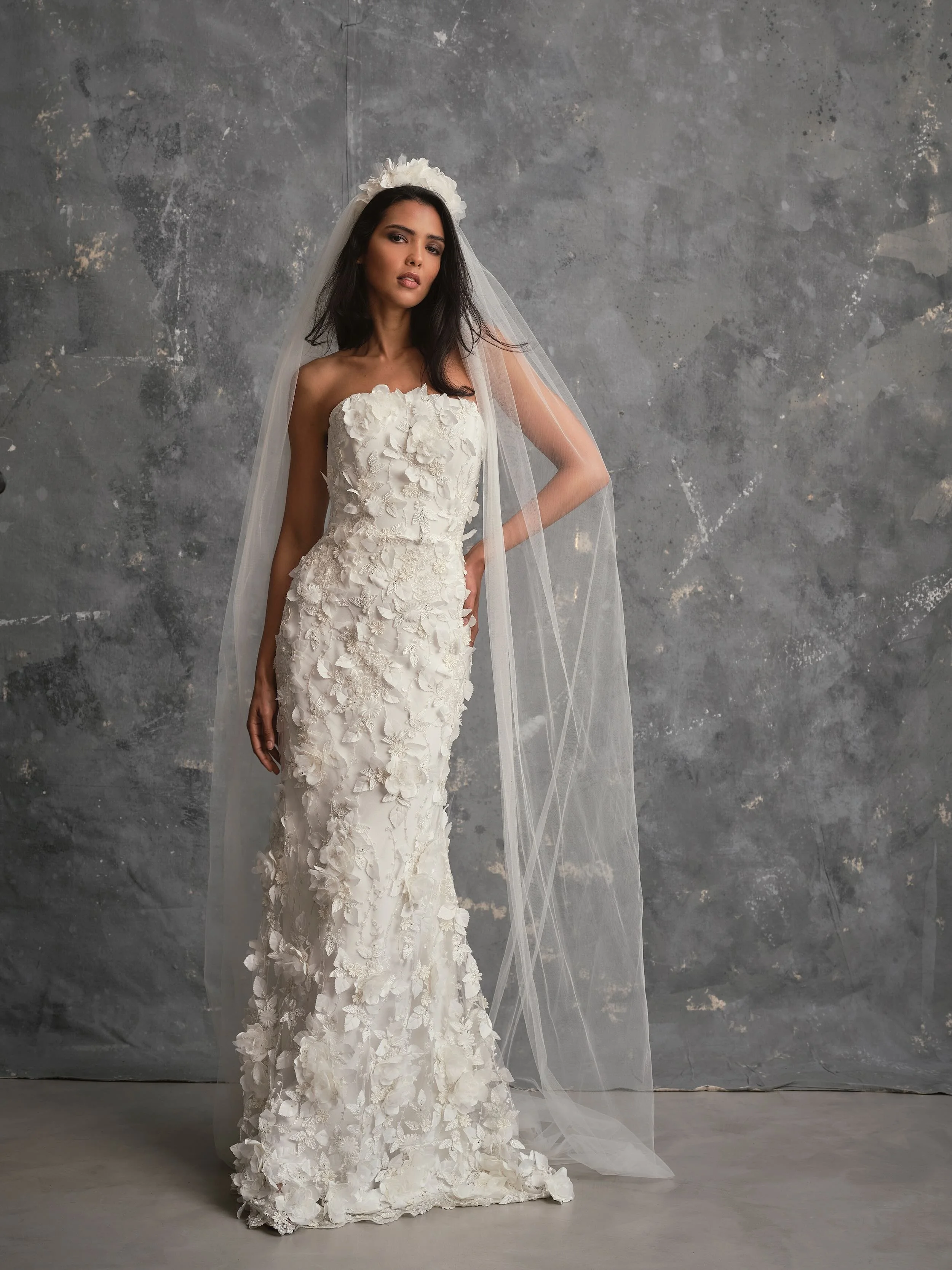 Modern fitted wedding dress covered with floral appliqué and floral crown veil