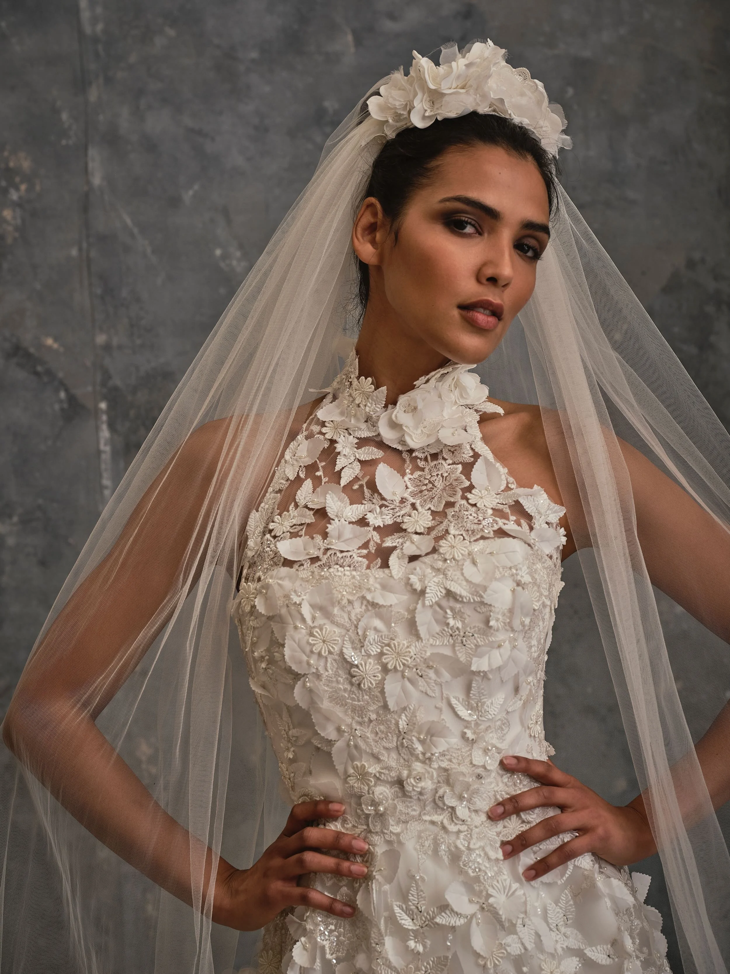 Detailed close-up of 3D floral appliqué bodice with illusion neckline and couture embroidery and matching handmade silk flower crown tulle veil