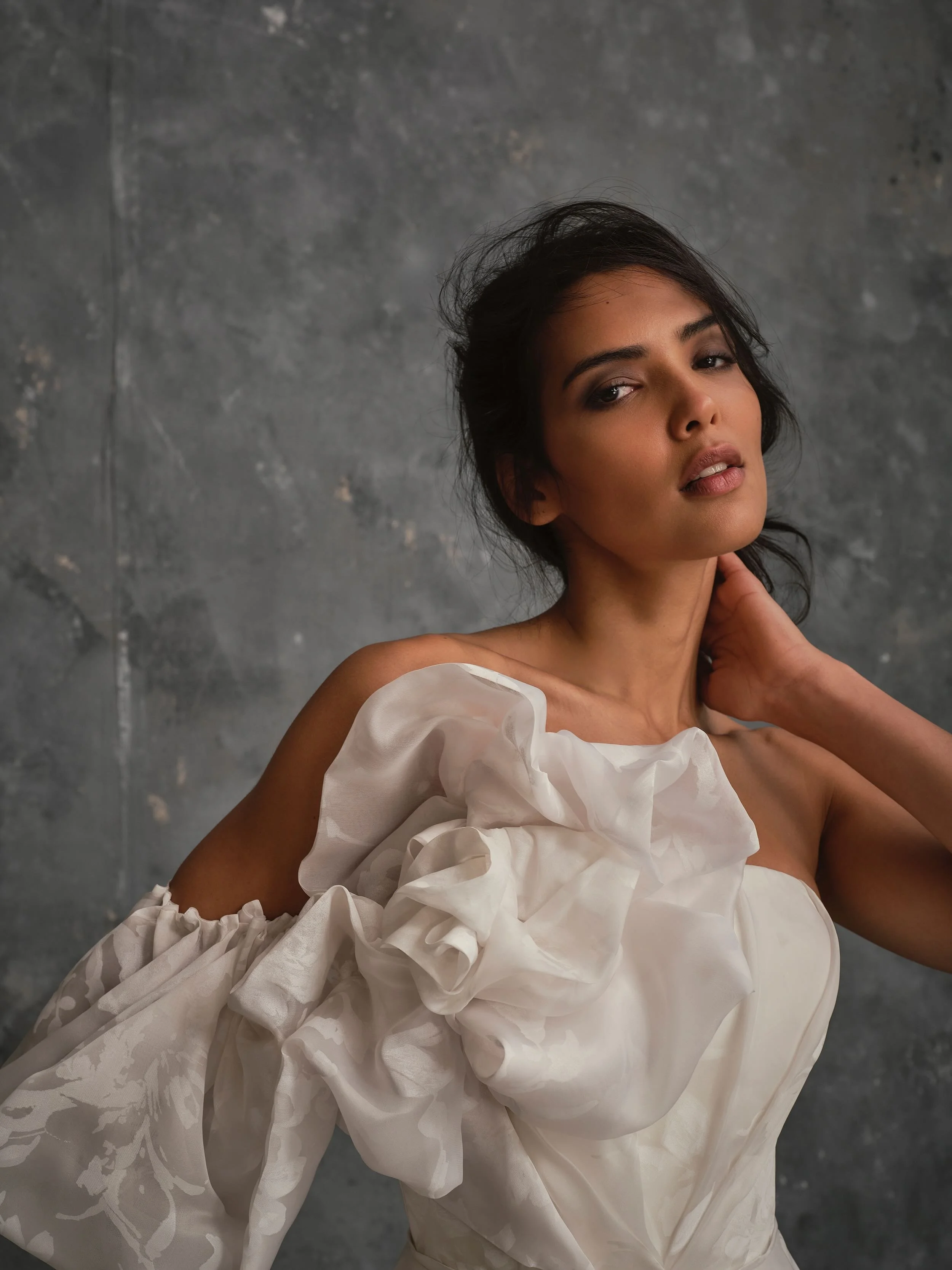 Lily's sculptural floral organza detail creates a contemporary couture statement.