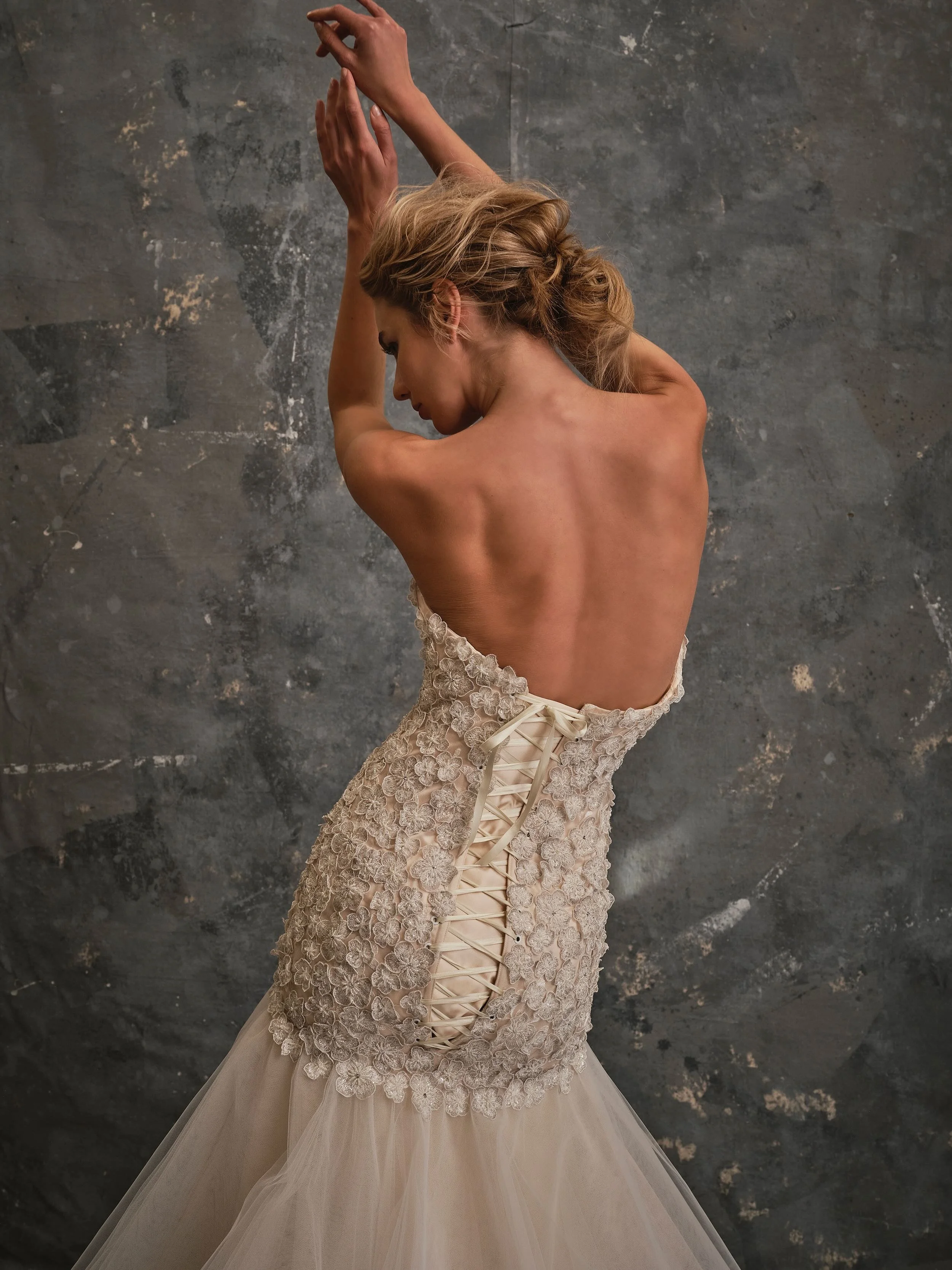 Back view of Floriana bridal gown featuring floral lace texture and corset lace-up back