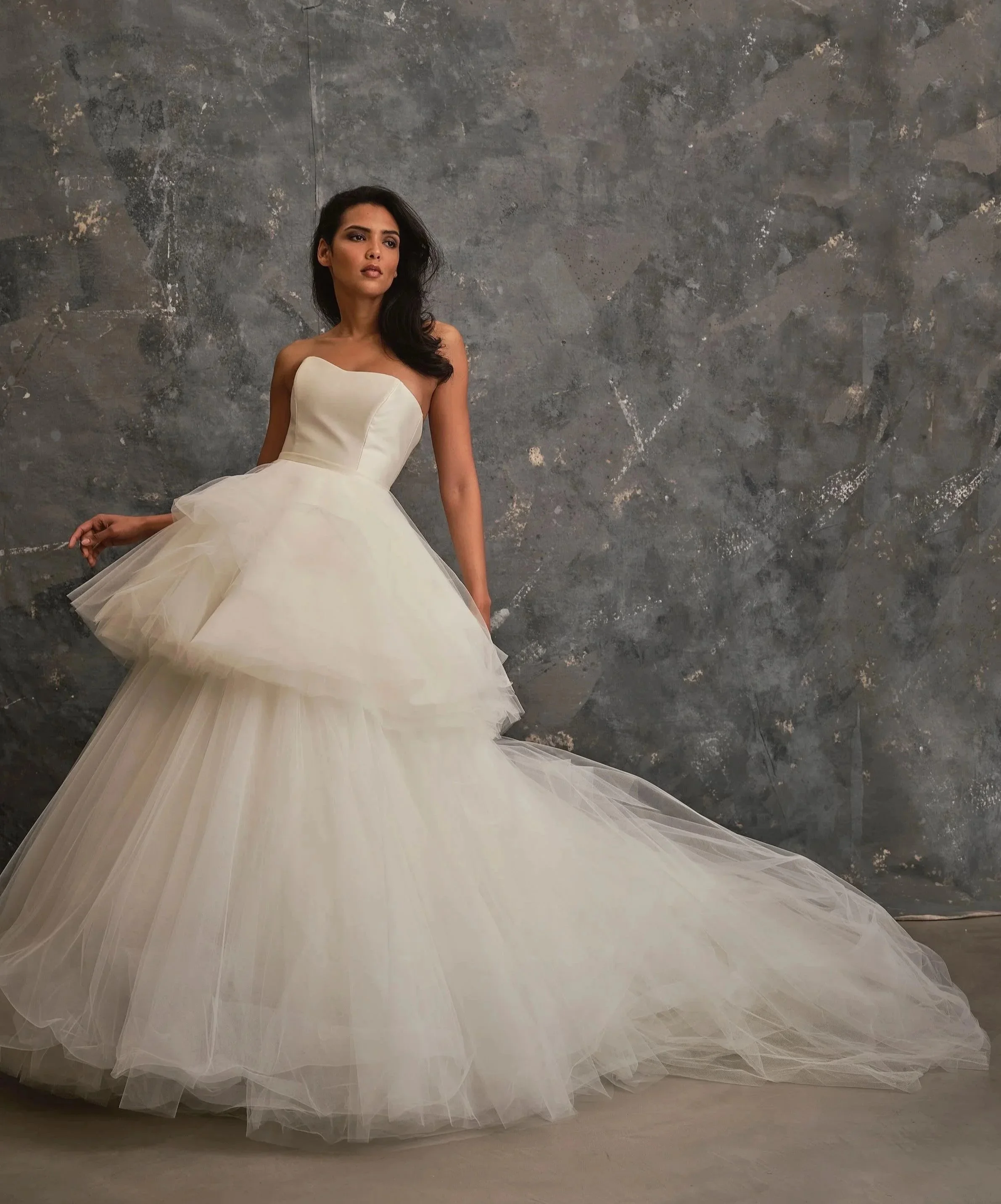 Strapless wedding gown with voluminous layered tulle skirt and contemporary bridal silhouette