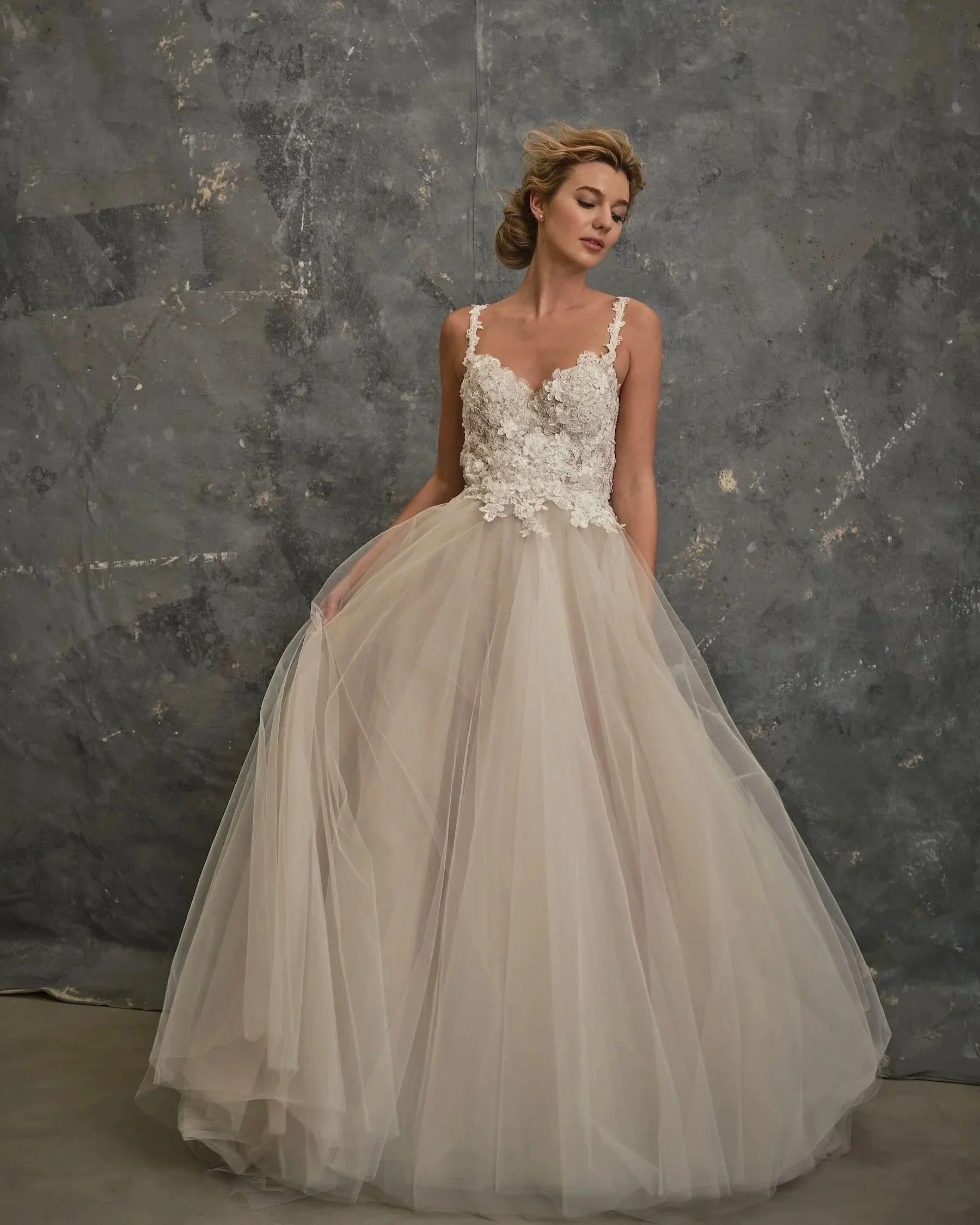Ballerina wedding dress with floral lace bodice and layered tulle skirt at The Couture Gallery London