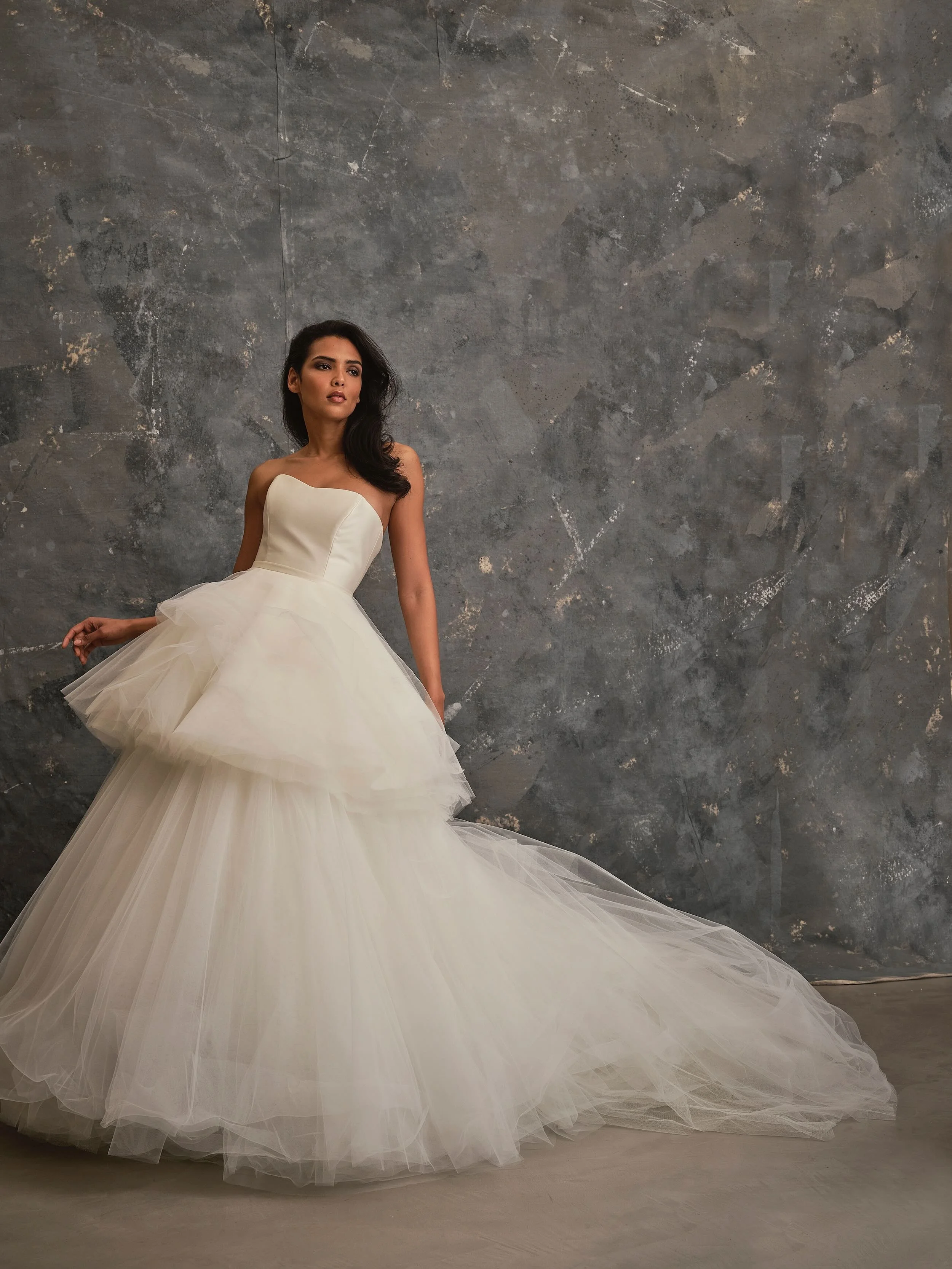 Modern convertible wedding dress with structured sweetheart bodice and dramatic layered tulle ballgown skirt