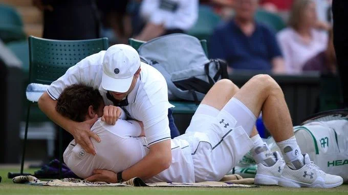 Andy Murray receiving an adjustment mid-match.