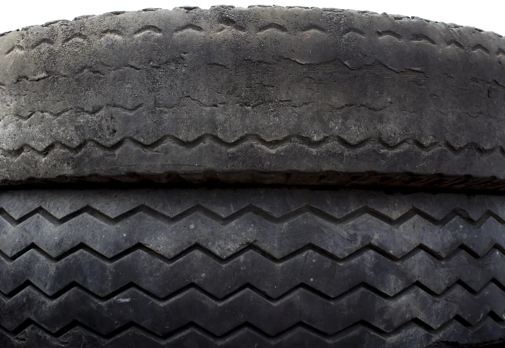 This photo exhibits what abnormal loading can do to tires. There is nothing inherently wrong with the abnormally worn tire, it was just loaded more than the other. Increasing its potential for blowing out sooner.