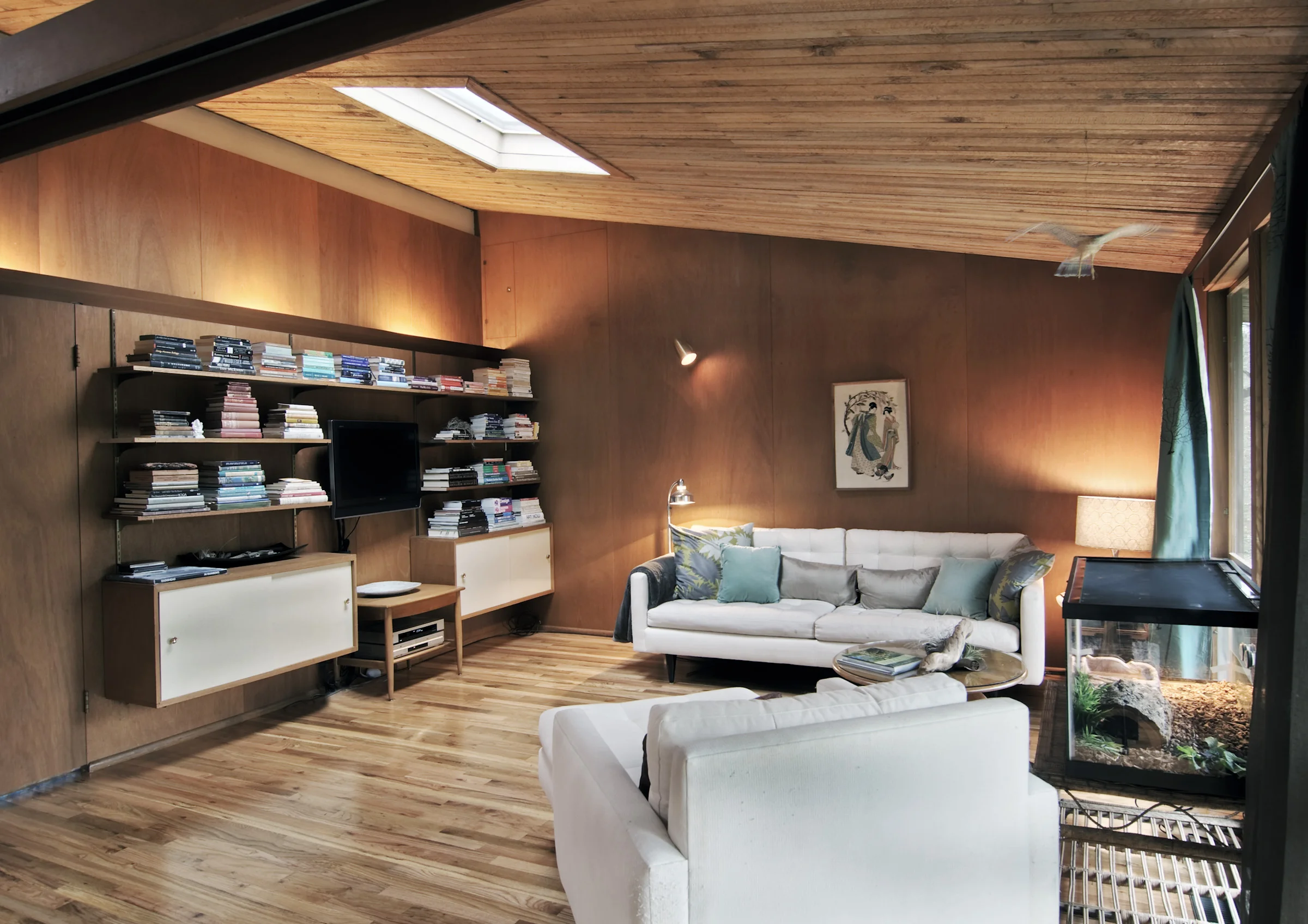 All interior walls are restored mahogany. The ceiling is composed of rough hewn cedar 2x4's with a metal i-beam down the center to carry load and eliminate the need for interior partitioning walls.