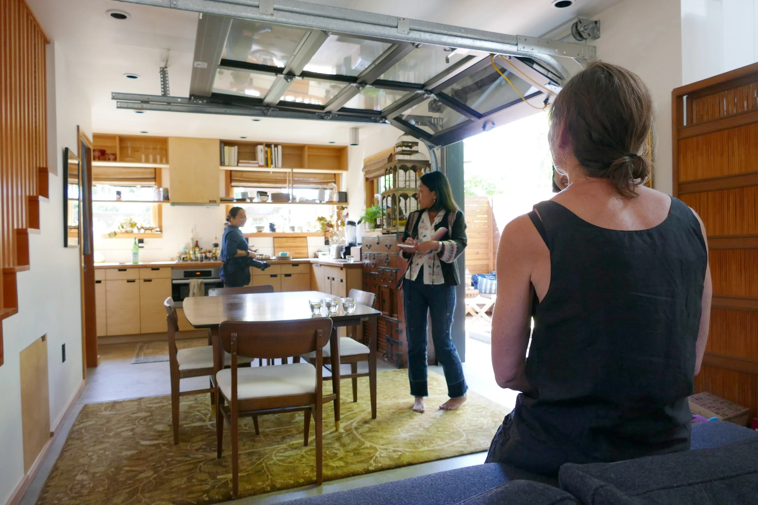 The photographer makes note of kitchen and food items she can use as props for the session while the editor, Megumi, checks her shot list with areas around the property. Shannon patiently waiting to be directed in outfit #1.