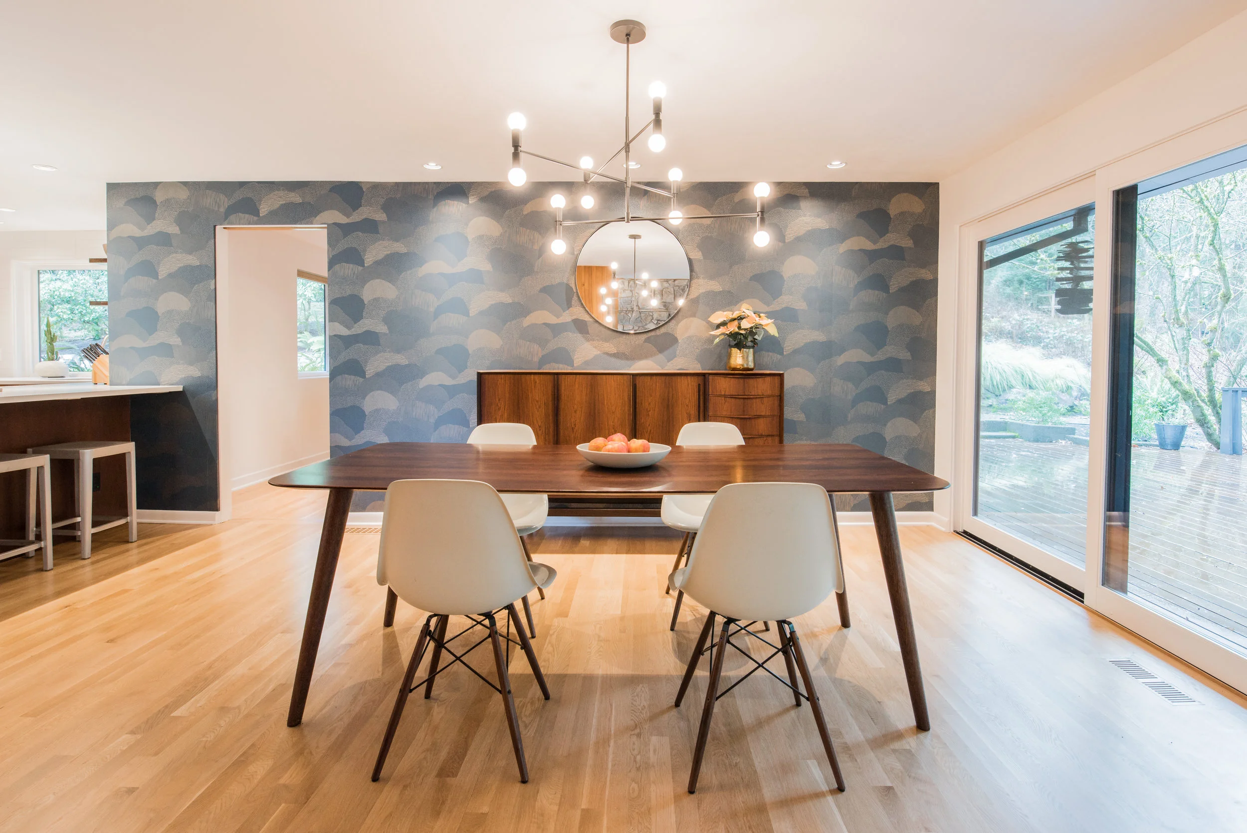 For the dining room walls, the homeowners chose “Roll Right - Gold on Blue” by Makelike, their favorite Portland wallpaper company.