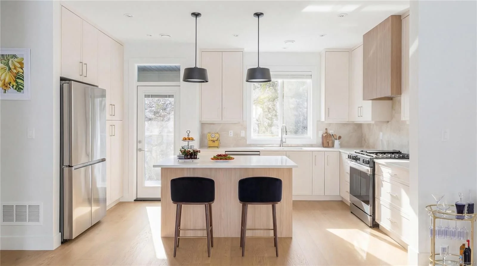 Bright and light kitchen with custom cabinetry and an island.