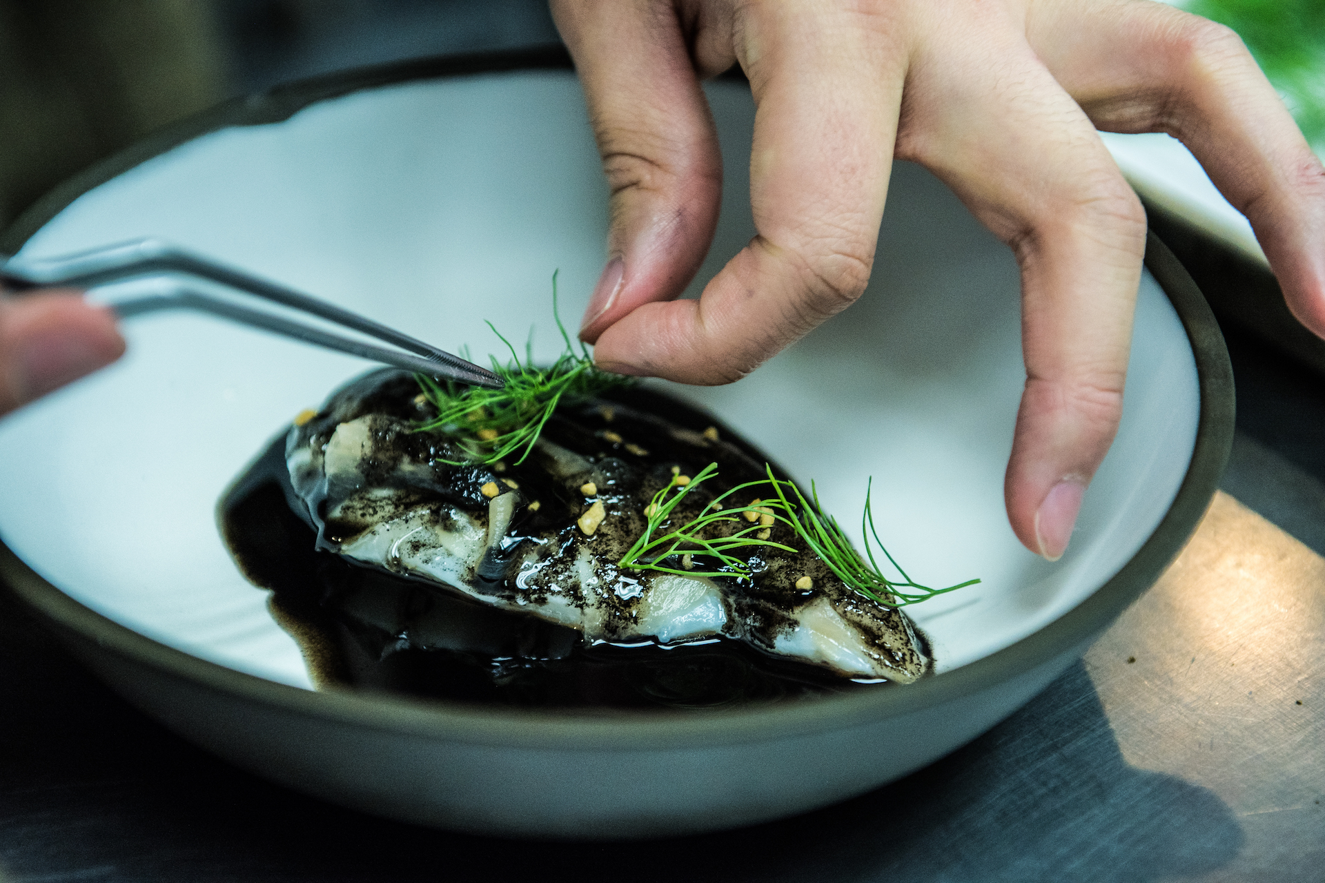 Preparing the halibut dish.
