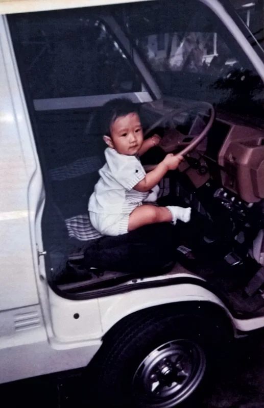 Musa in his first car. Courtesy of Musa Tjahjono.