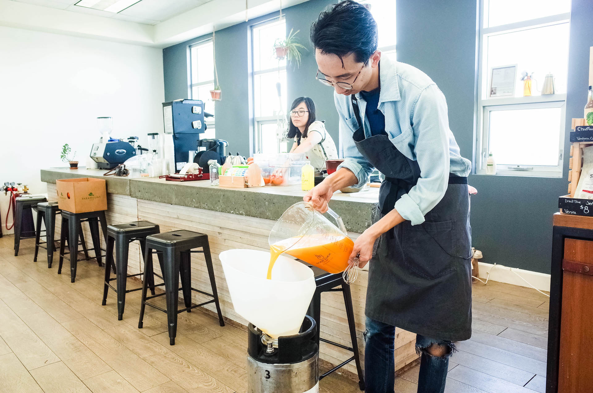 Chris pouring the orange cream concoction in a keg.