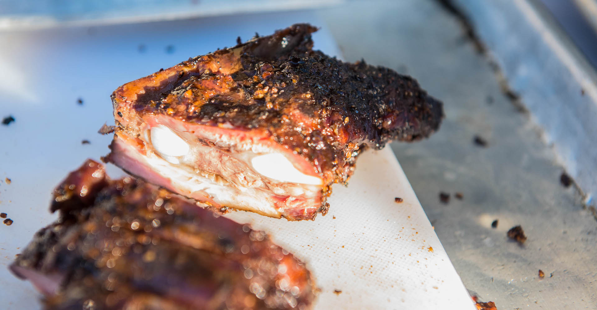 The layers of fat, meat, and bone of the brisket.