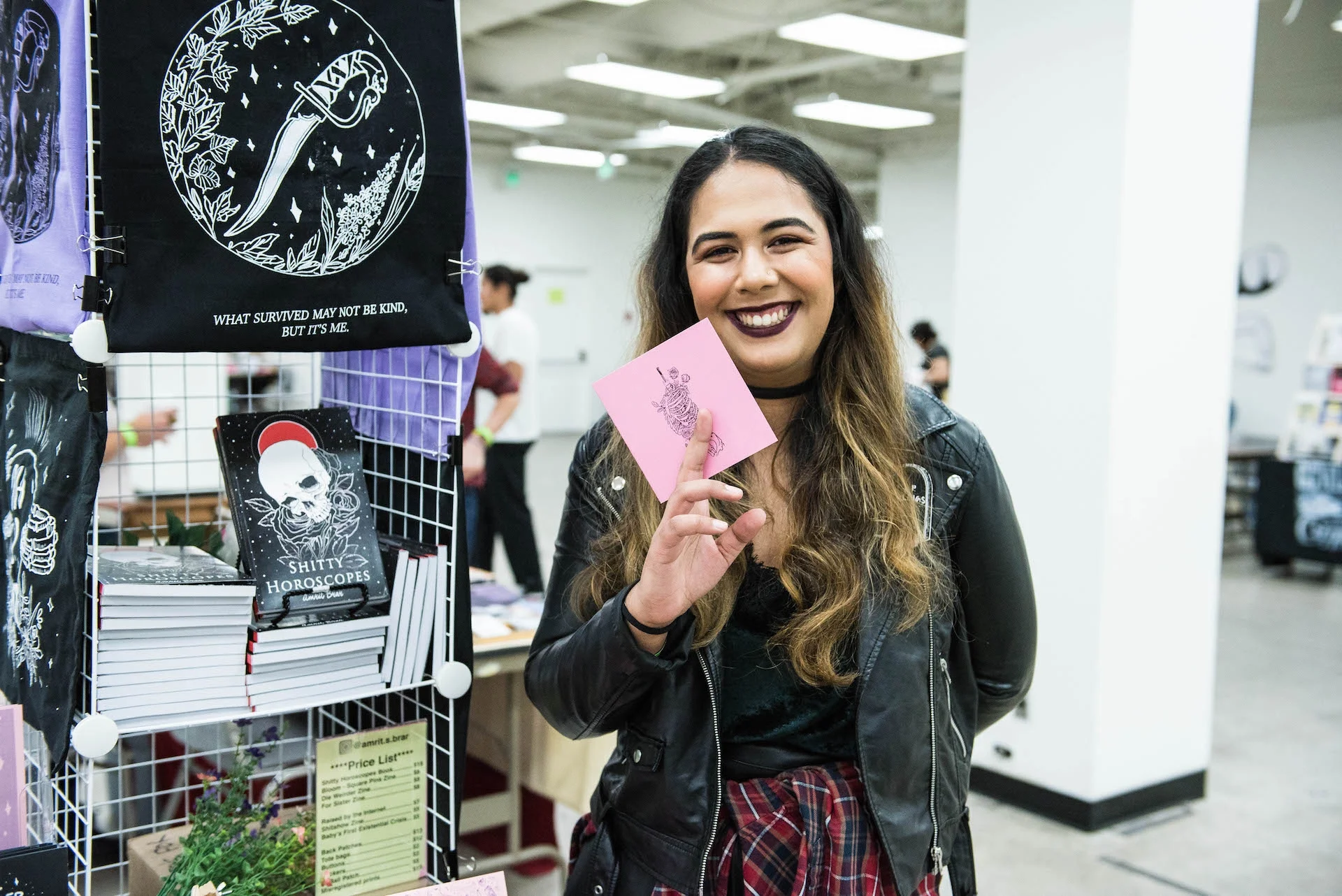 Amrit holds up one of her zines.