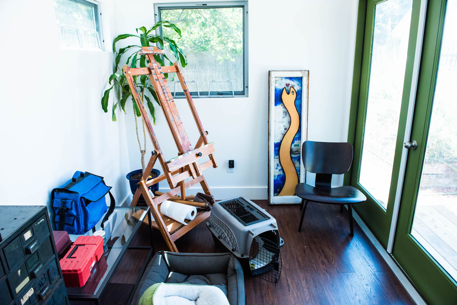 The studio is outfitted with an easel, art materials, inspiring art, and cozy places for her dogs.
