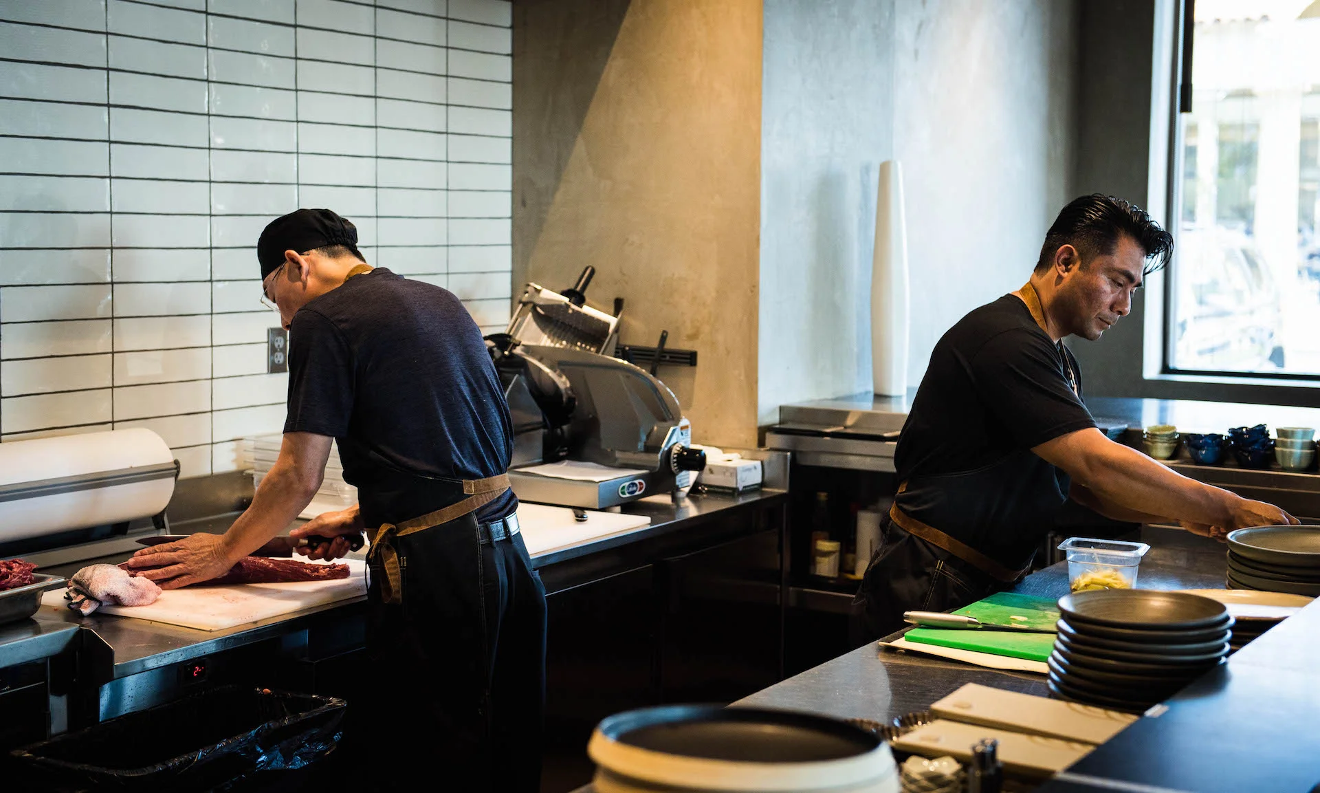 The chefs prepare the delicious meats.