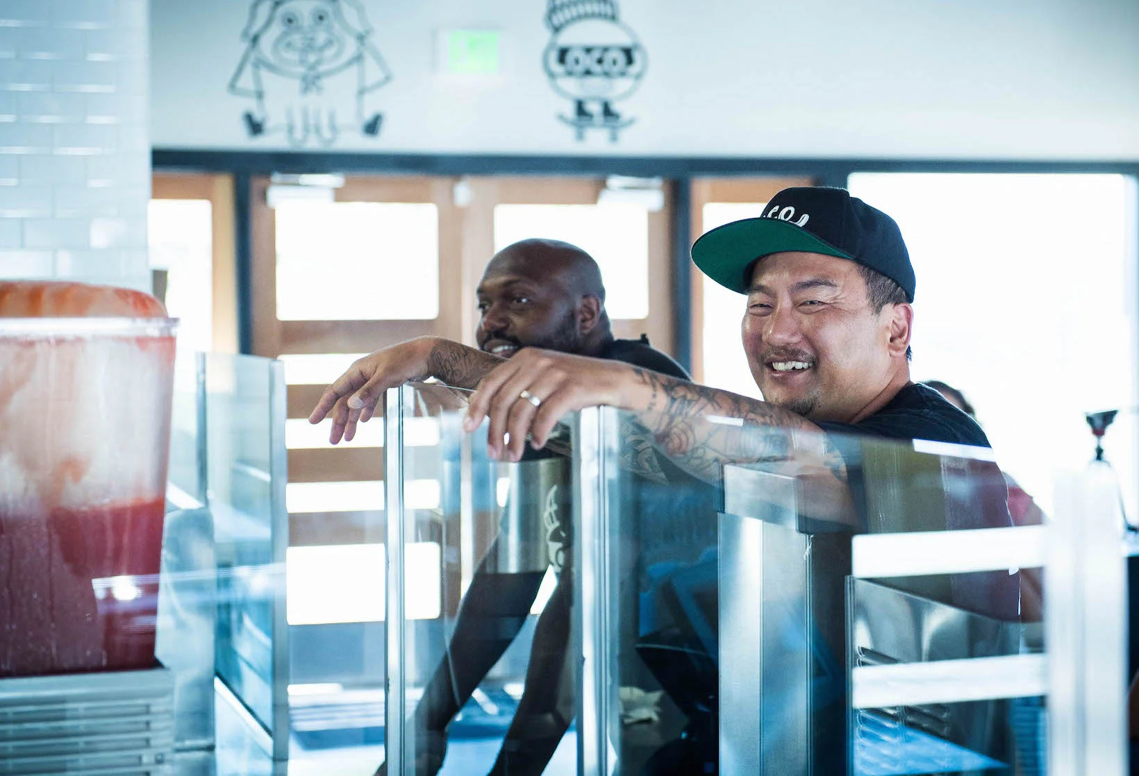 Roy Choi (right) in front of Locol in Watts with one of his managers, Terry (left).