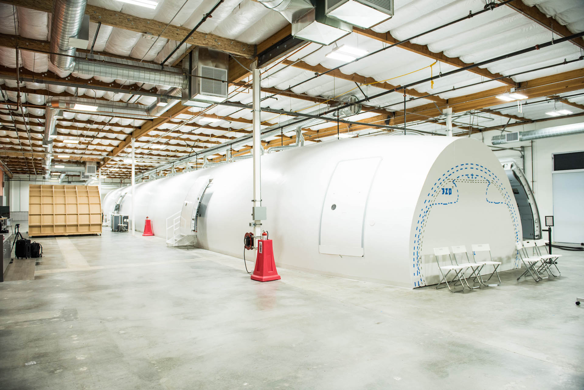 The entirety of the mockup. You can see it's completely housed inside this warehouse. On the right side you can see the outlines of an A-320 Airbus plane. 