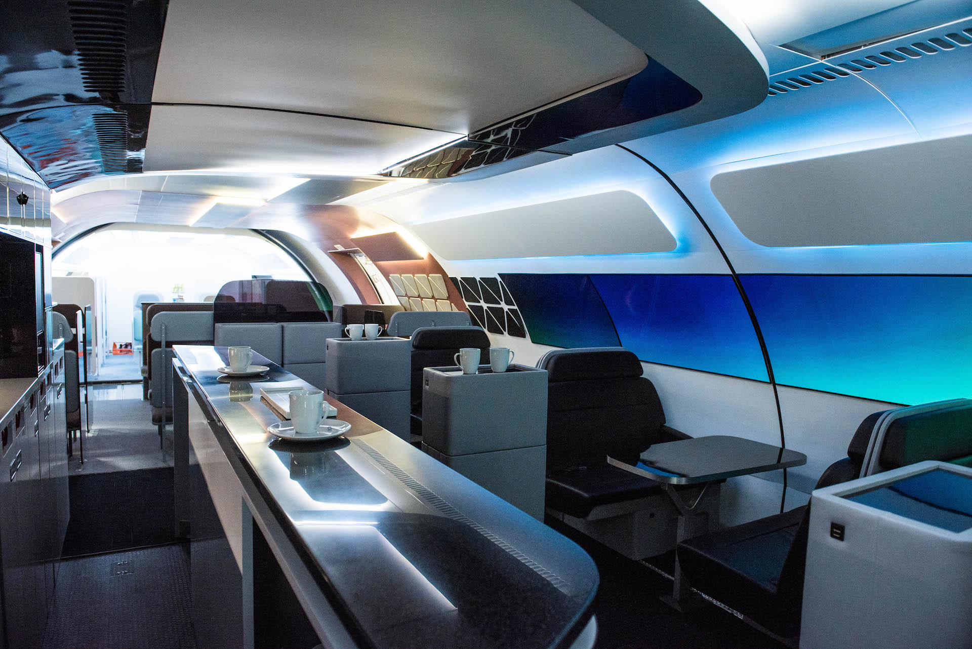 Yes, that's a restaurant in a plane. Dining tables and a coffee bar reside in this module. Also, those gray columns in the middle? They are also chairs. It's a chable.