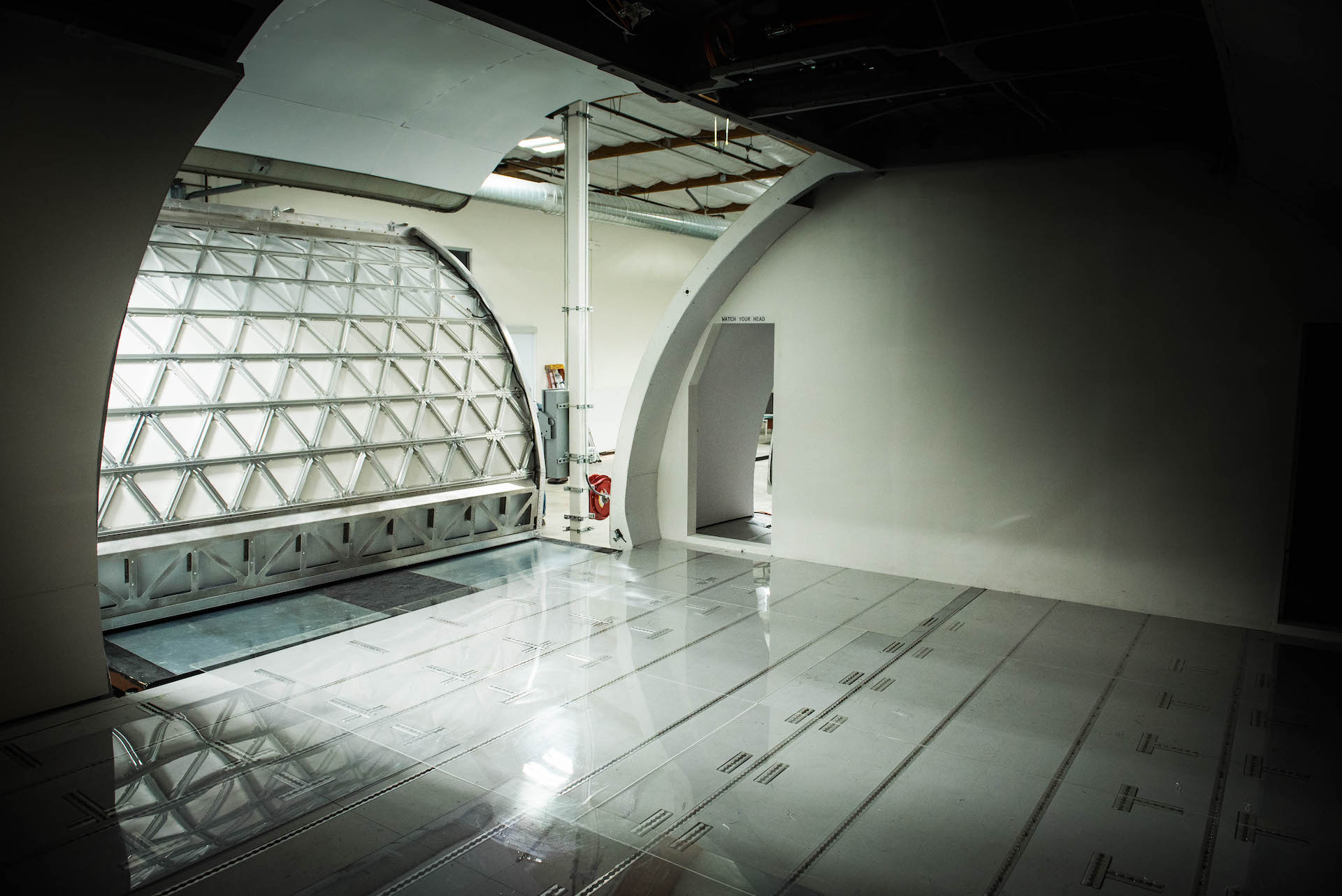 From inside the plane. The module glides on plexiglass and underneath the module is an air disc that helps it glide. Think airplane air hockey puck.