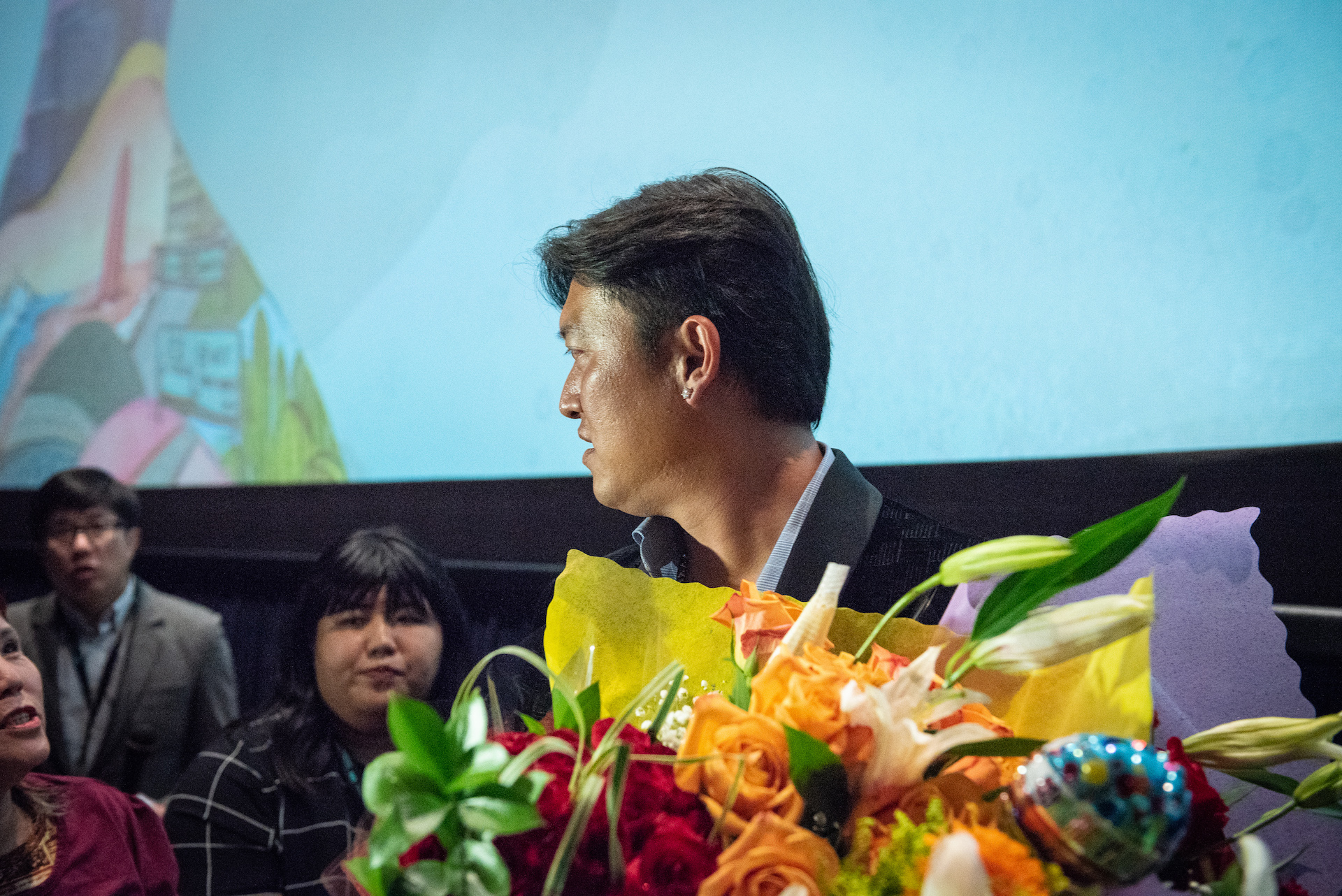 Fans give Wang flowers after the premiere.