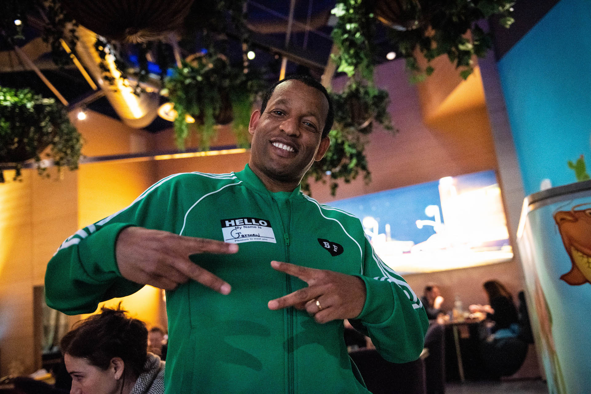 Our waiter, “G”, in 80s track suit attire.