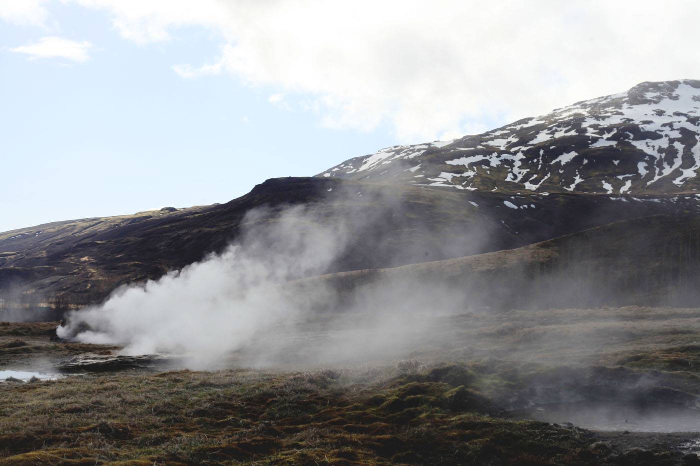 Smoke rising from the smaller baby geysers along the path to the Strokkur Geysir.