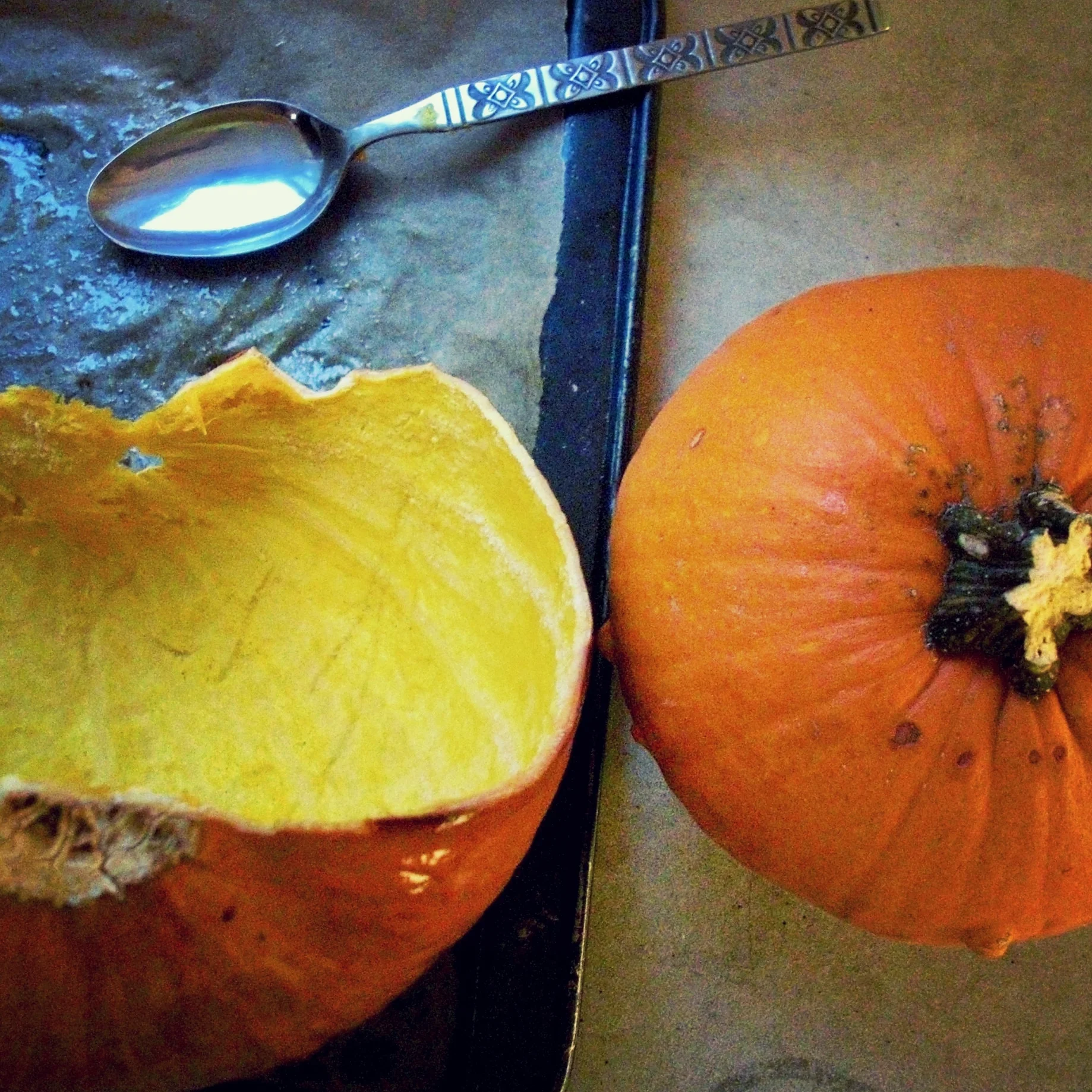 Roasting and scooping out fresh sugar pumpkins for pie.